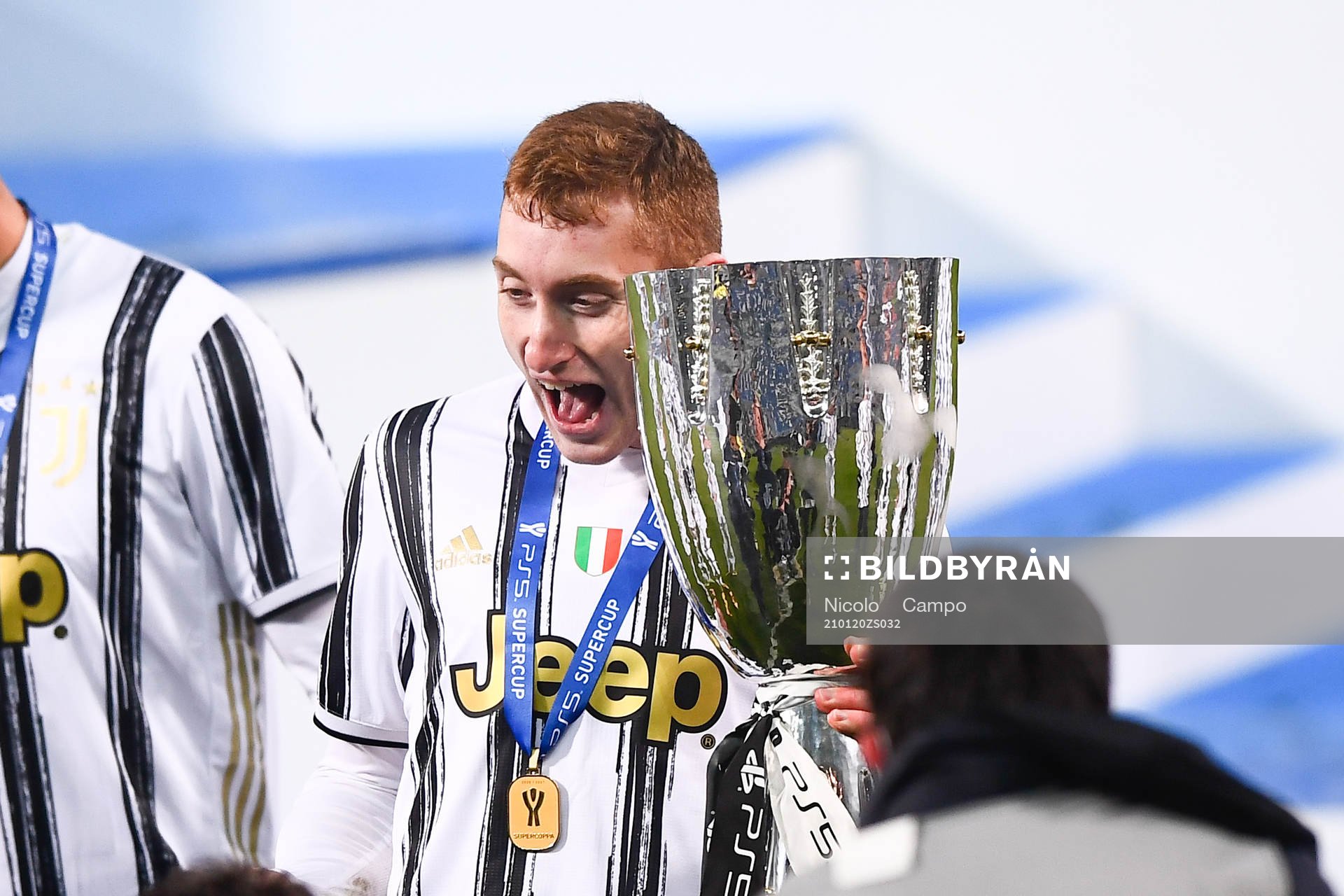 Dejan Kulusevski of Juventus celebrates with the trophy