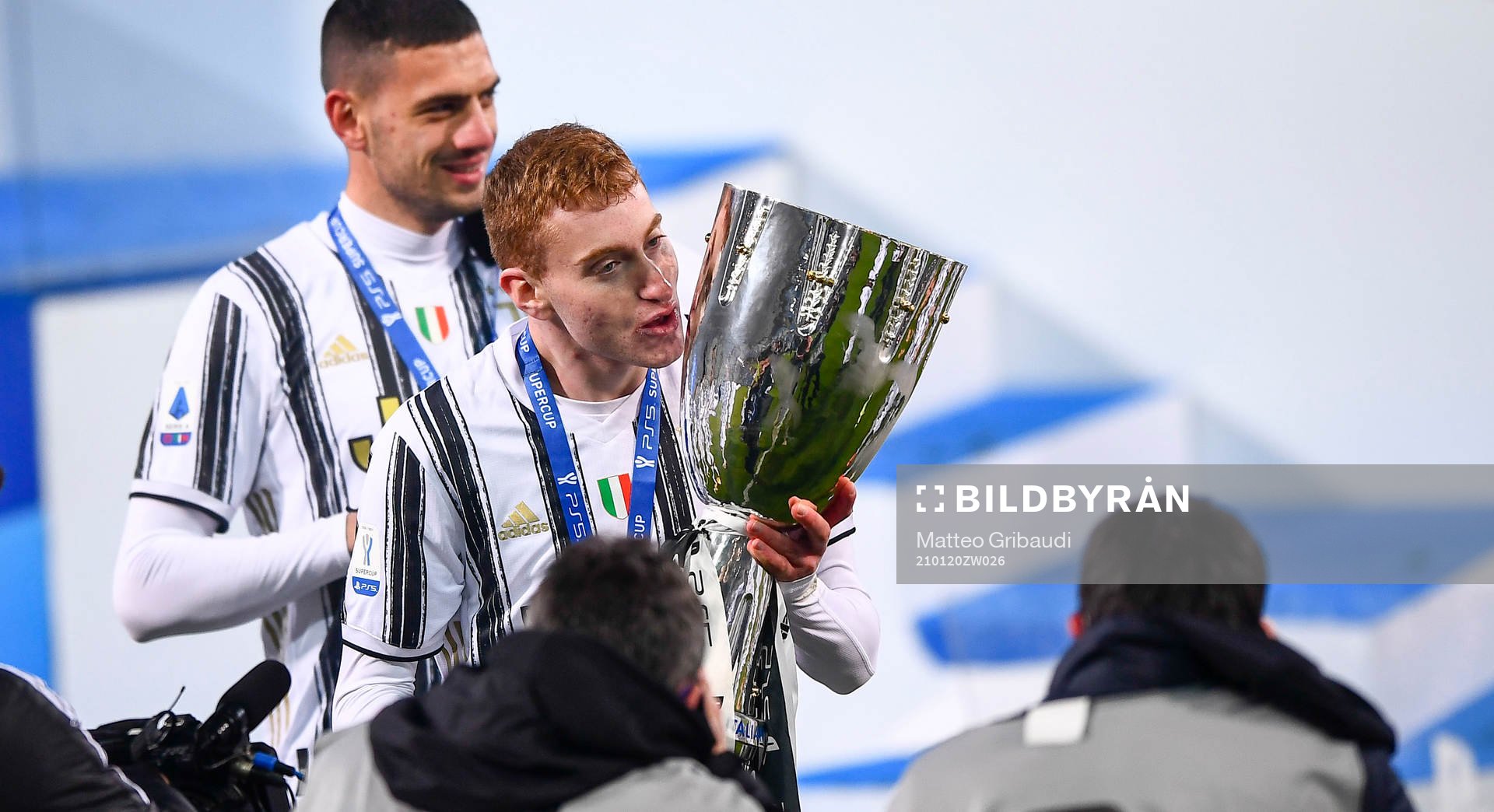 Dejan Kulusevski of Juventus celebrates with the trophy