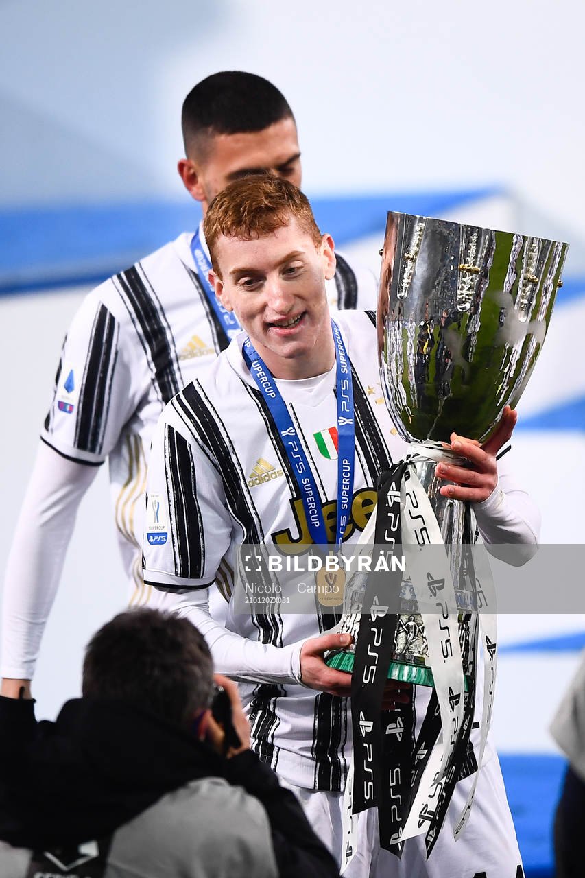 Dejan Kulusevski of Juventus celebrates with the trophy