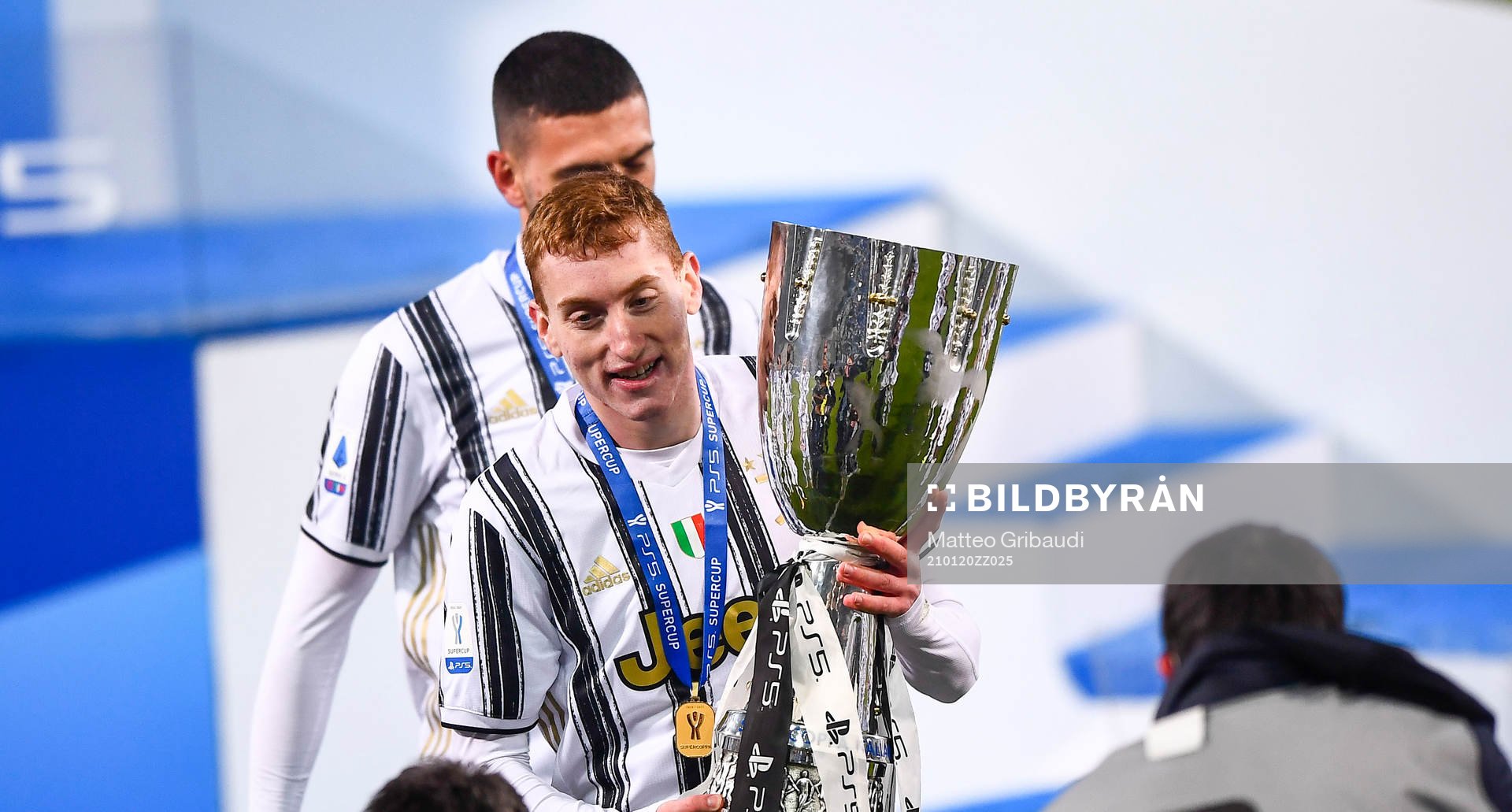 Dejan Kulusevski of Juventus celebrates with the trophy