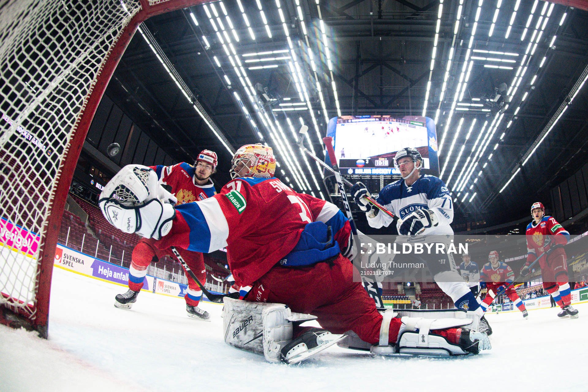 Juuso Puustinen of Finland and goalkeeper Alexander Samonov