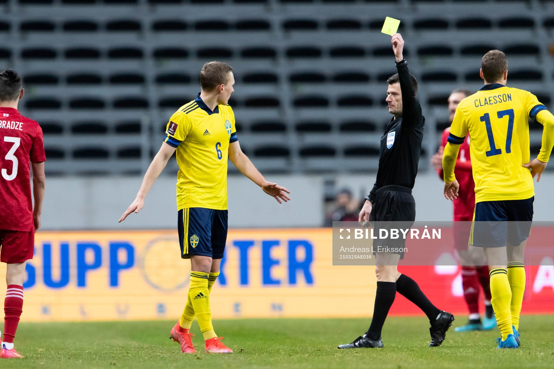 Ludwig Augustinsson of Sweden is shown a yellow card