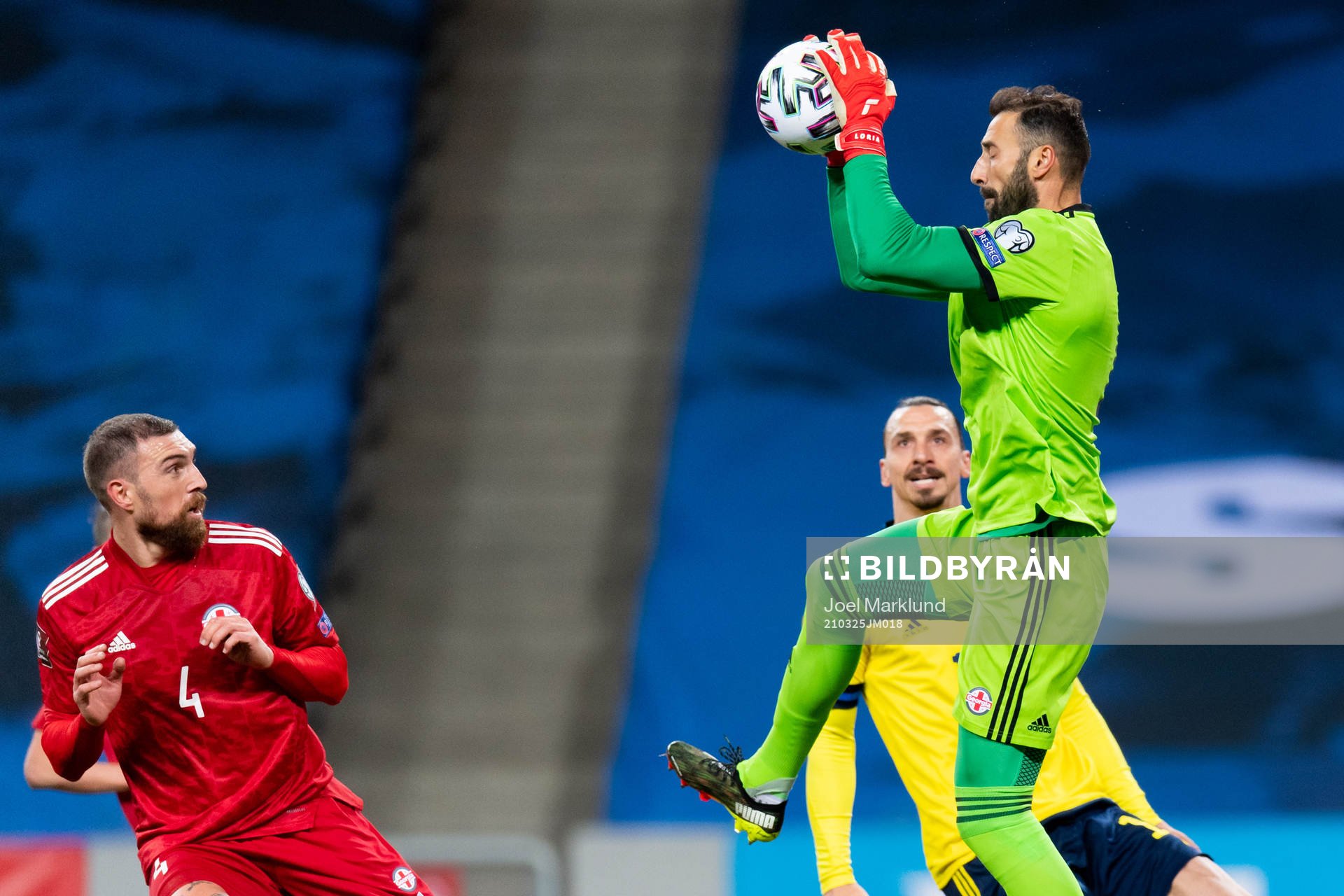 Guram Kashia and goalkeeper Giorgi Loria of Georgia against