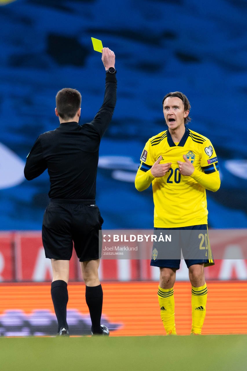 Kristoffer Olsson of Sweden is shown a yellow card