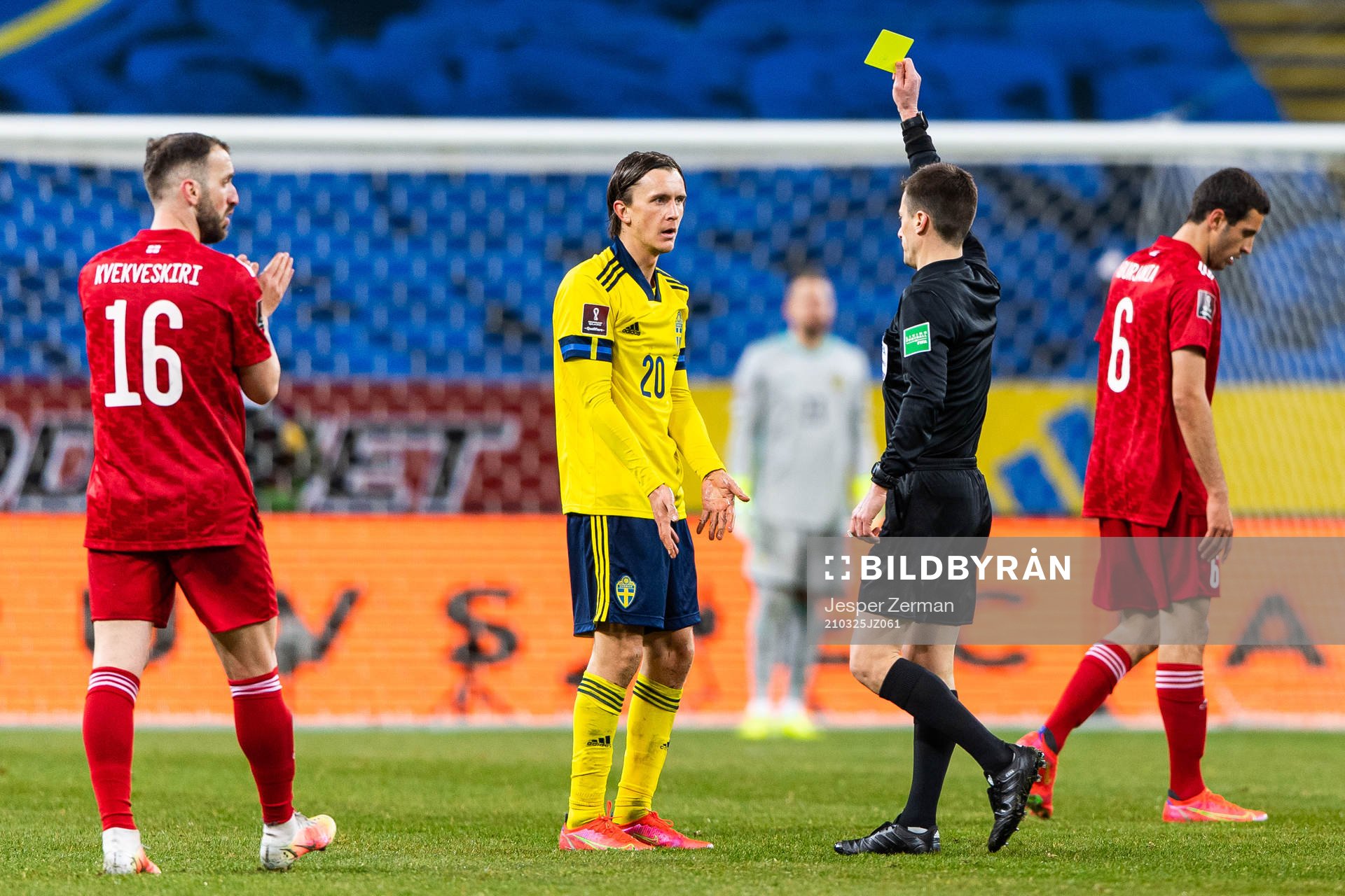 Kristoffer Olsson of Sweden receives a yellow card from