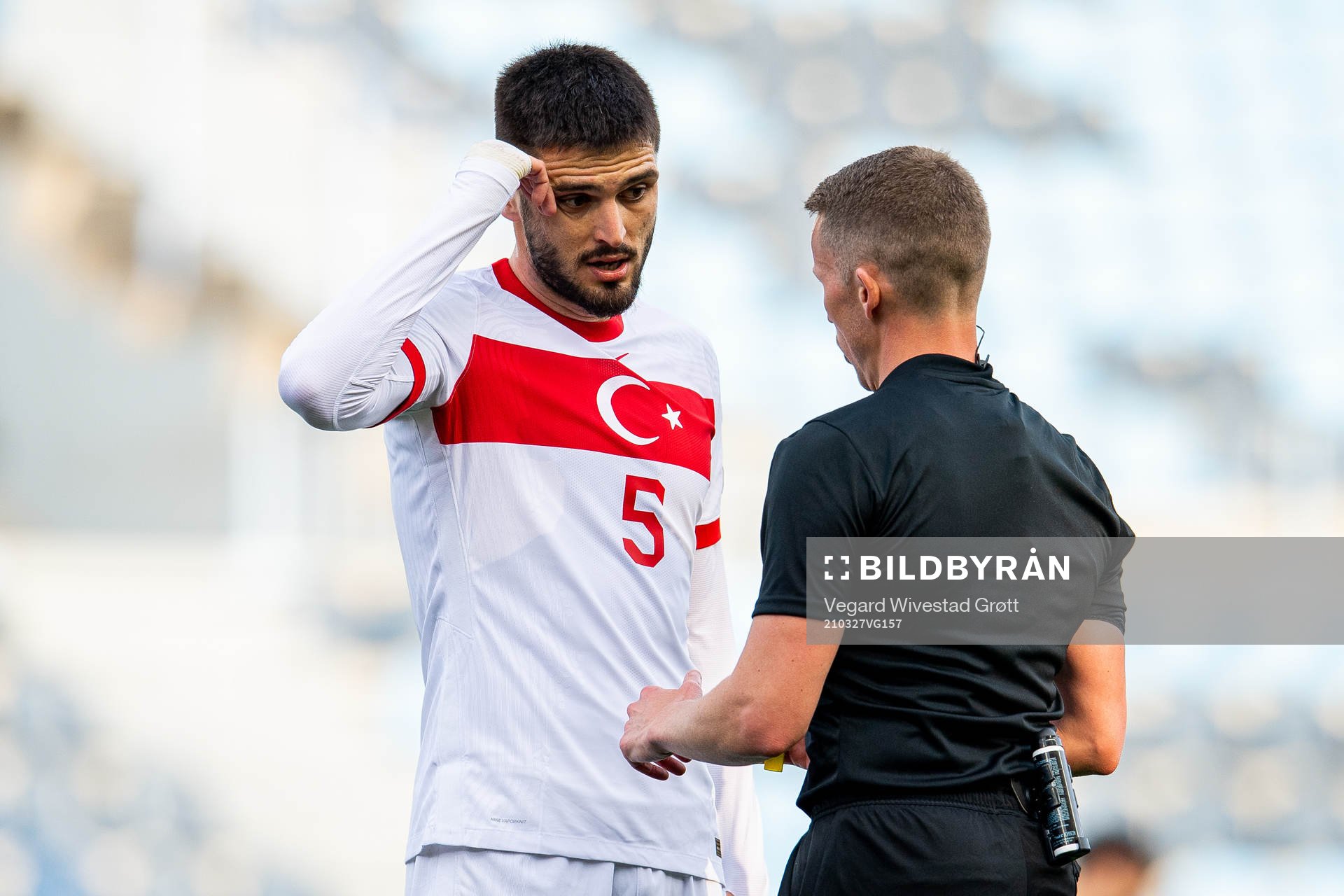 Okay Yokuslu of Turkey talks to referee Alejandro Hernandez during the FIFA World Cup Qualifier football match between Norway and Turkey on March 27, 2021 in Malaga.