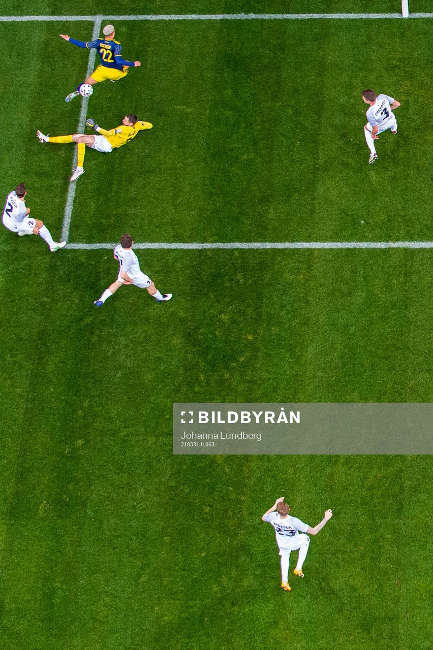 Robin Quaison of Sweden jumps over goalkeeper Matvei Igonen