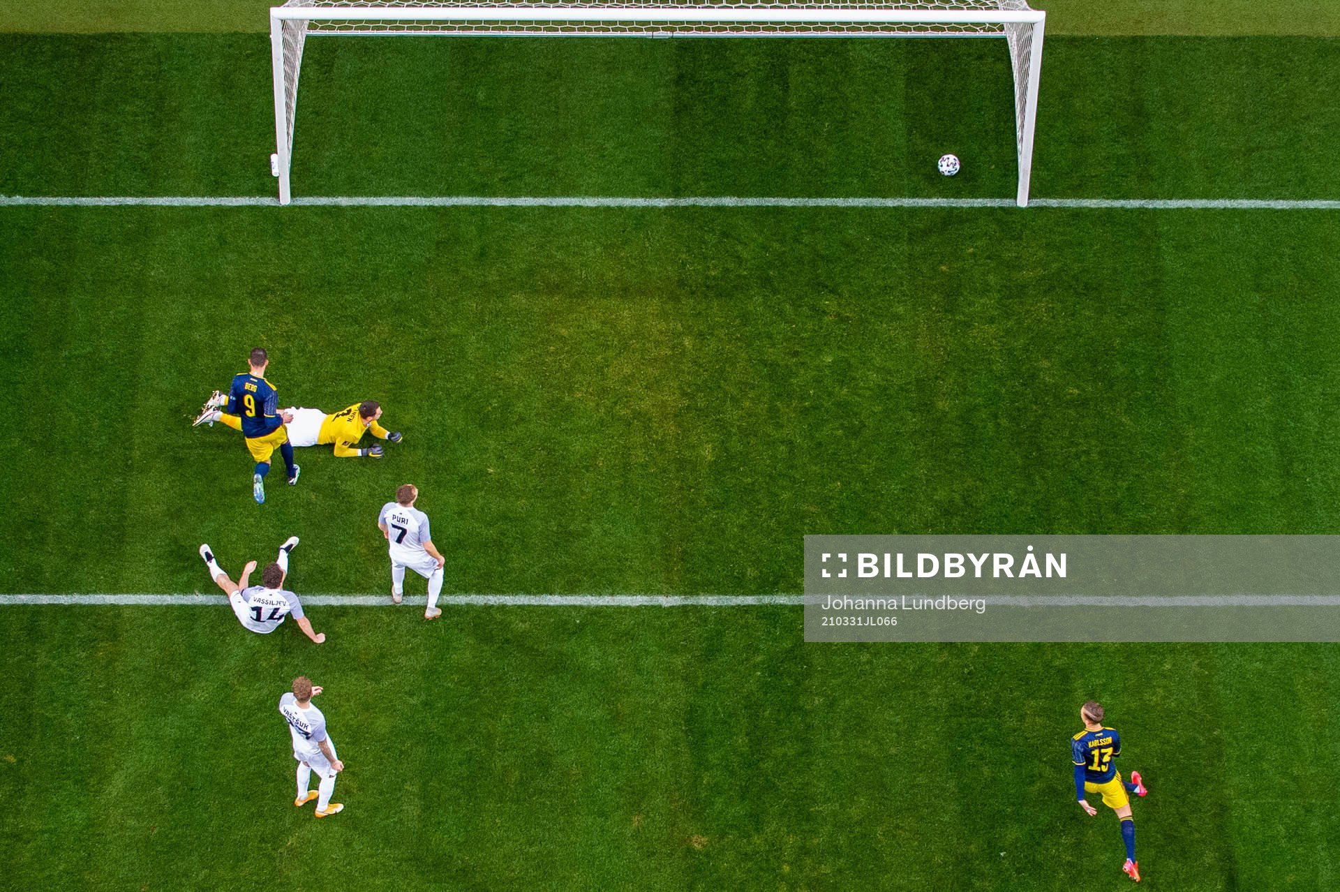 Marcus Berg of Sweden scores 1-0 beyond goalkeeper Matvei
