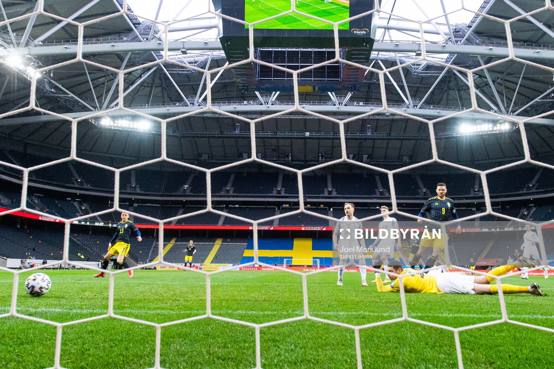 Marcus Berg of Sweden scores 1-0 behind goalkeeper Matvei