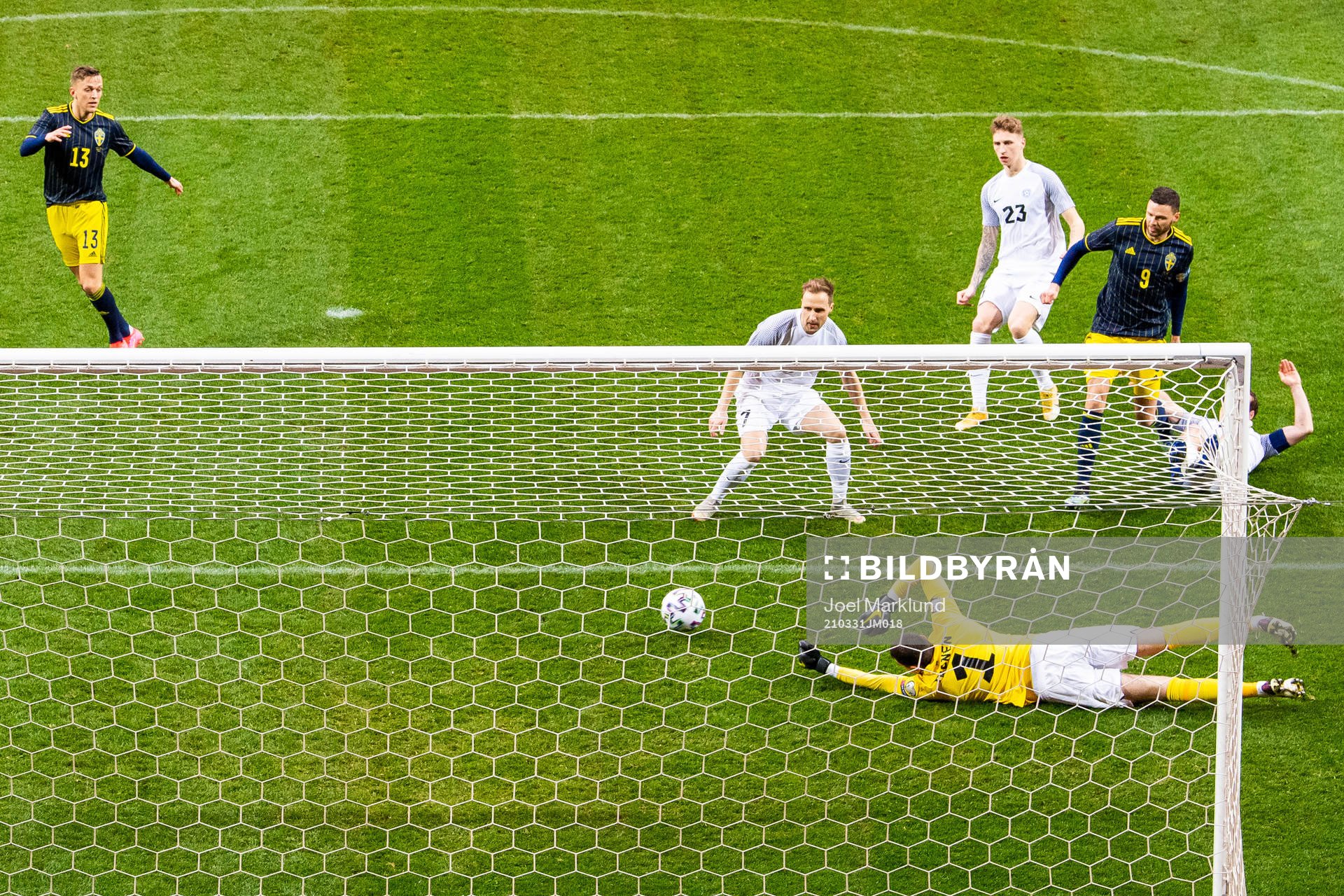 Marcus Berg of Sweden scores 1-0 behind goalkeeper Matvei