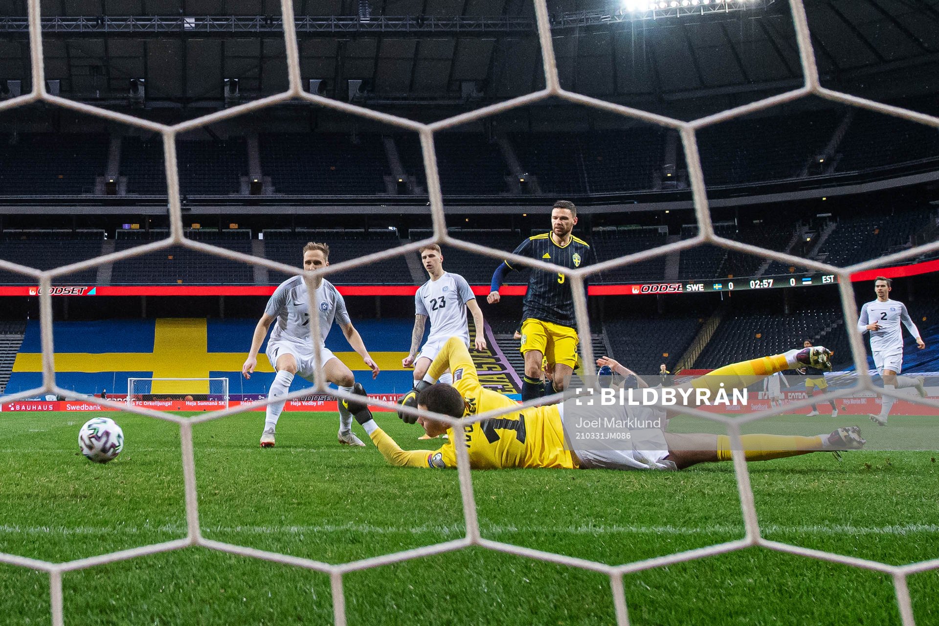 Marcus Berg of Sweden scores 1-0 behind goalkeeper Matvei