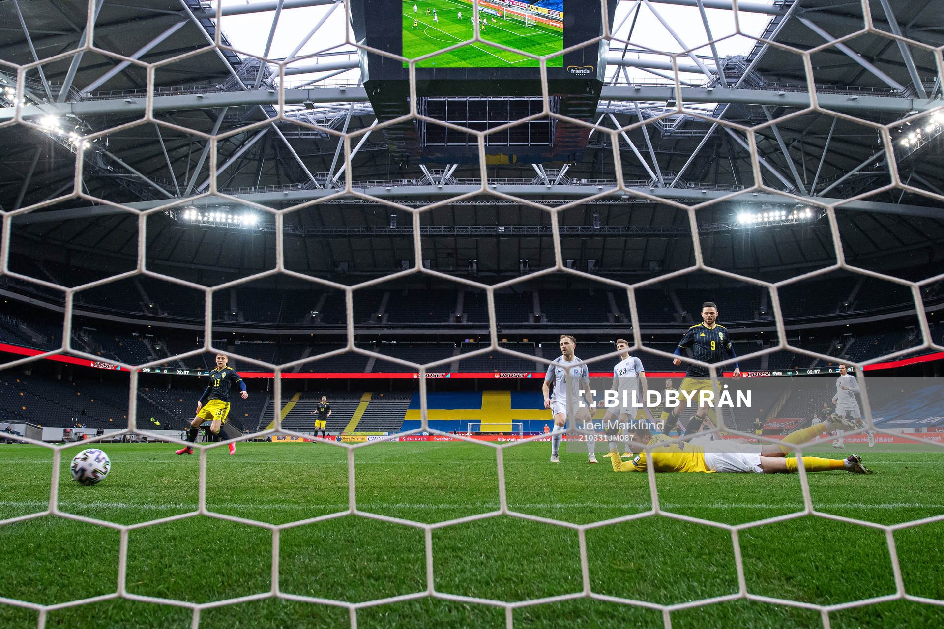 Marcus Berg of Sweden scores 1-0 behind goalkeeper Matvei