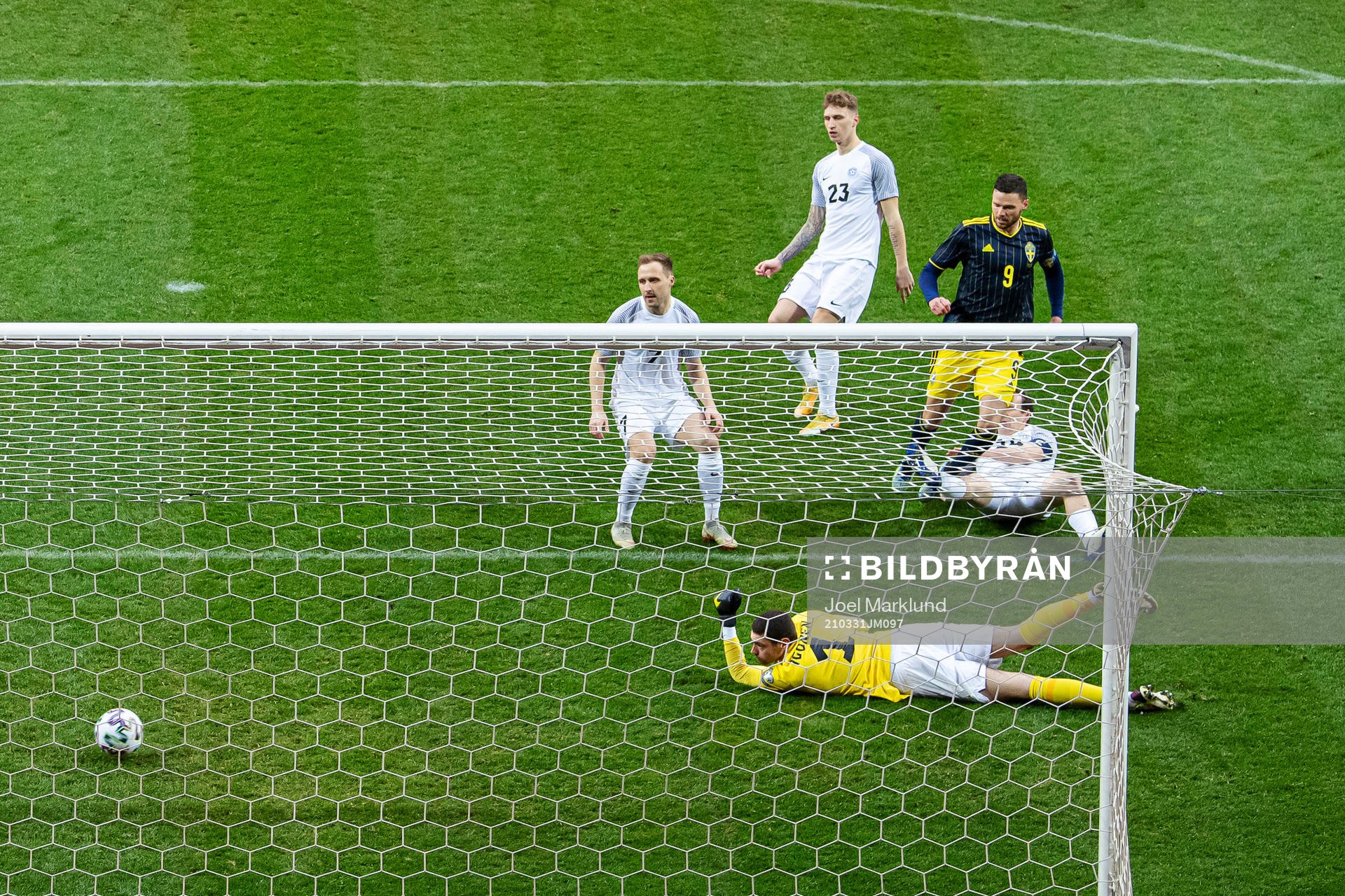 Marcus Berg of Sweden scores 1-0 behind goalkeeper Matvei