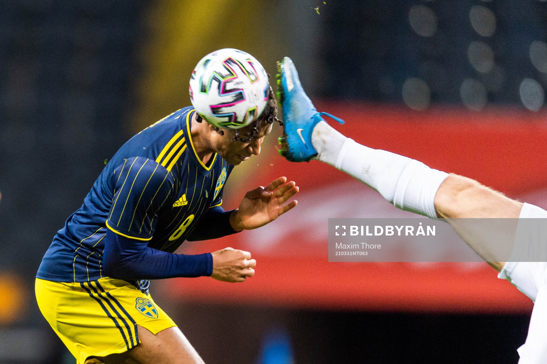 Jens-Lys Cajuste of Sweden is hit by a foot