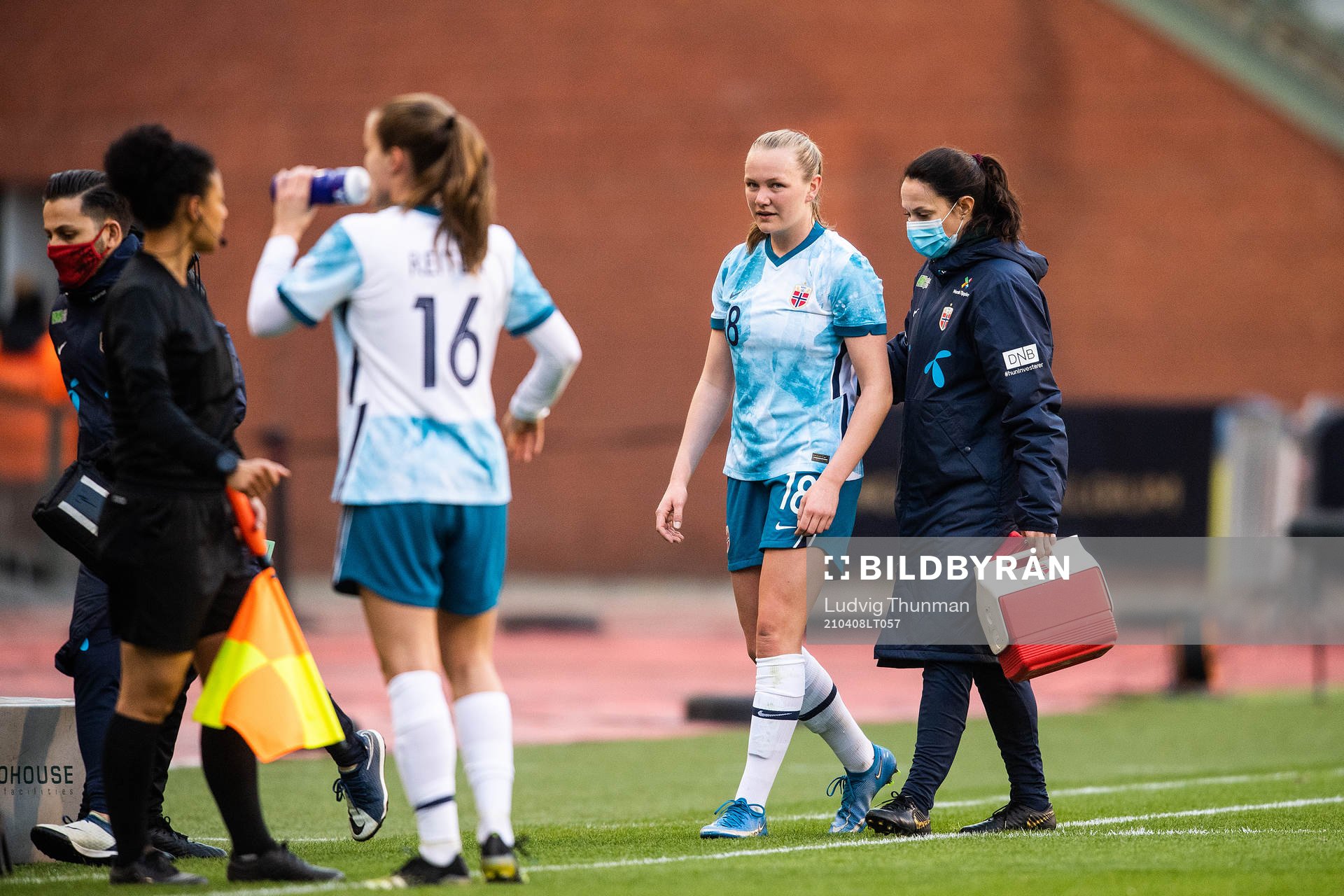 Frida Maanum of Norway leaves the pitch in pain