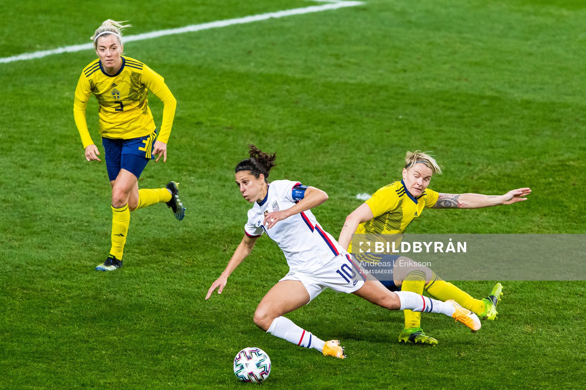 Carli Lloyd of USA and Nilla Fischer of Sweden compete for