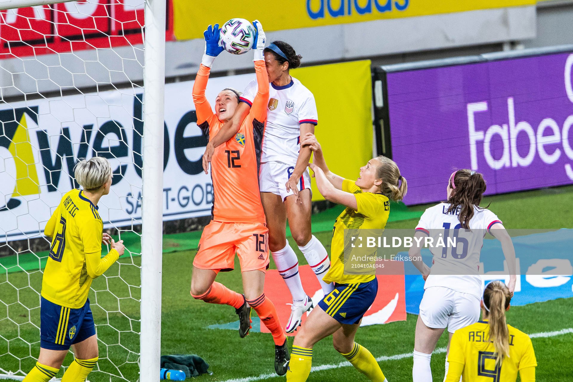 Goalkeeper Jennifer Falk of Sweden and Lynn Williams of USA