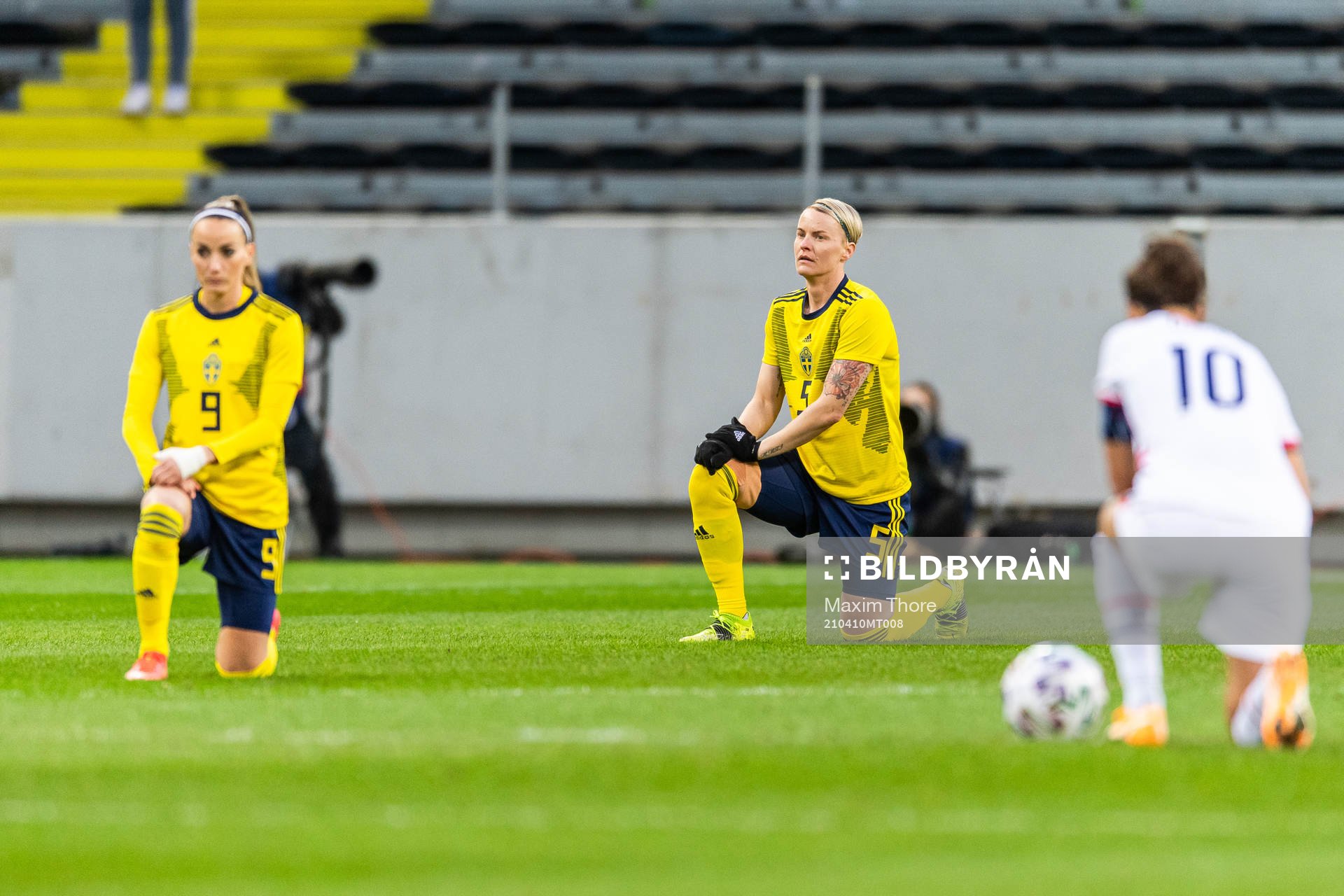 Kosovare Asllani and Nilla Fischer of Sweden takes a knee