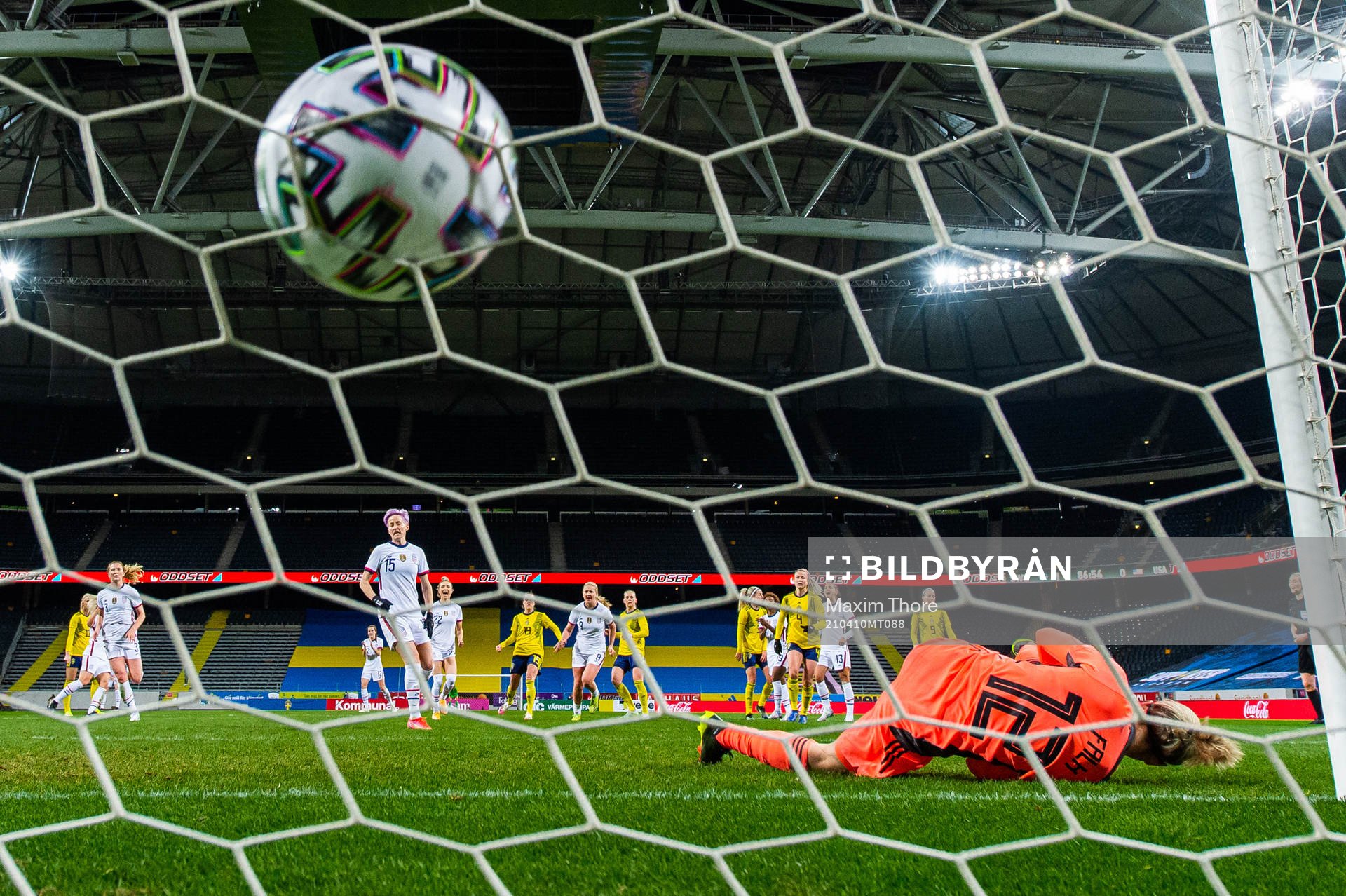 Megan Rapinoe of USA scores 1-1 behind goalkeeper Jennifer