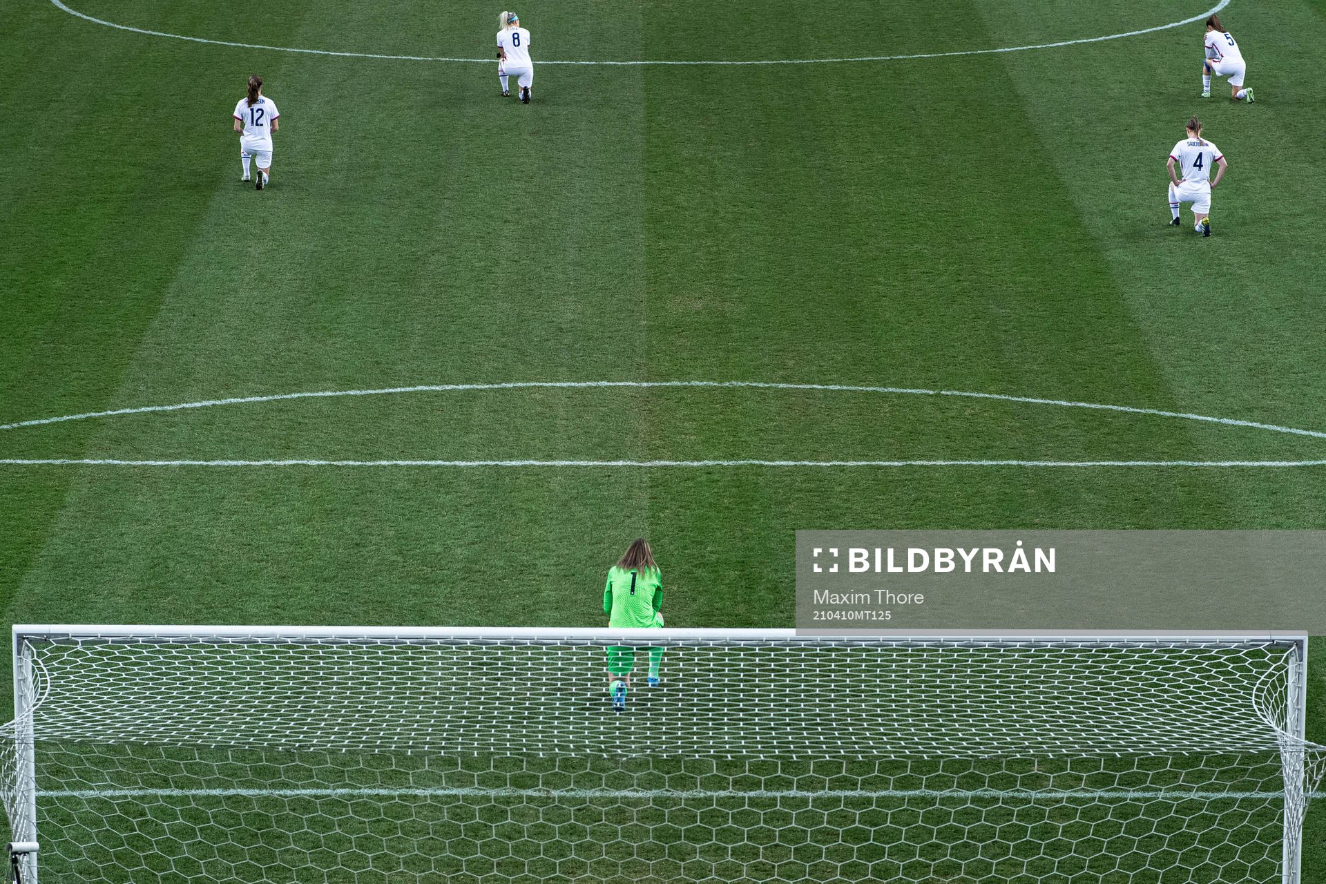 Goalkeeper Alyssa Naeher of USA takes a knee in support of