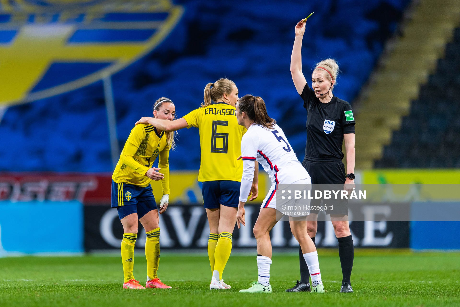 Kelley O’Hara of USA receives a yellow card from referee