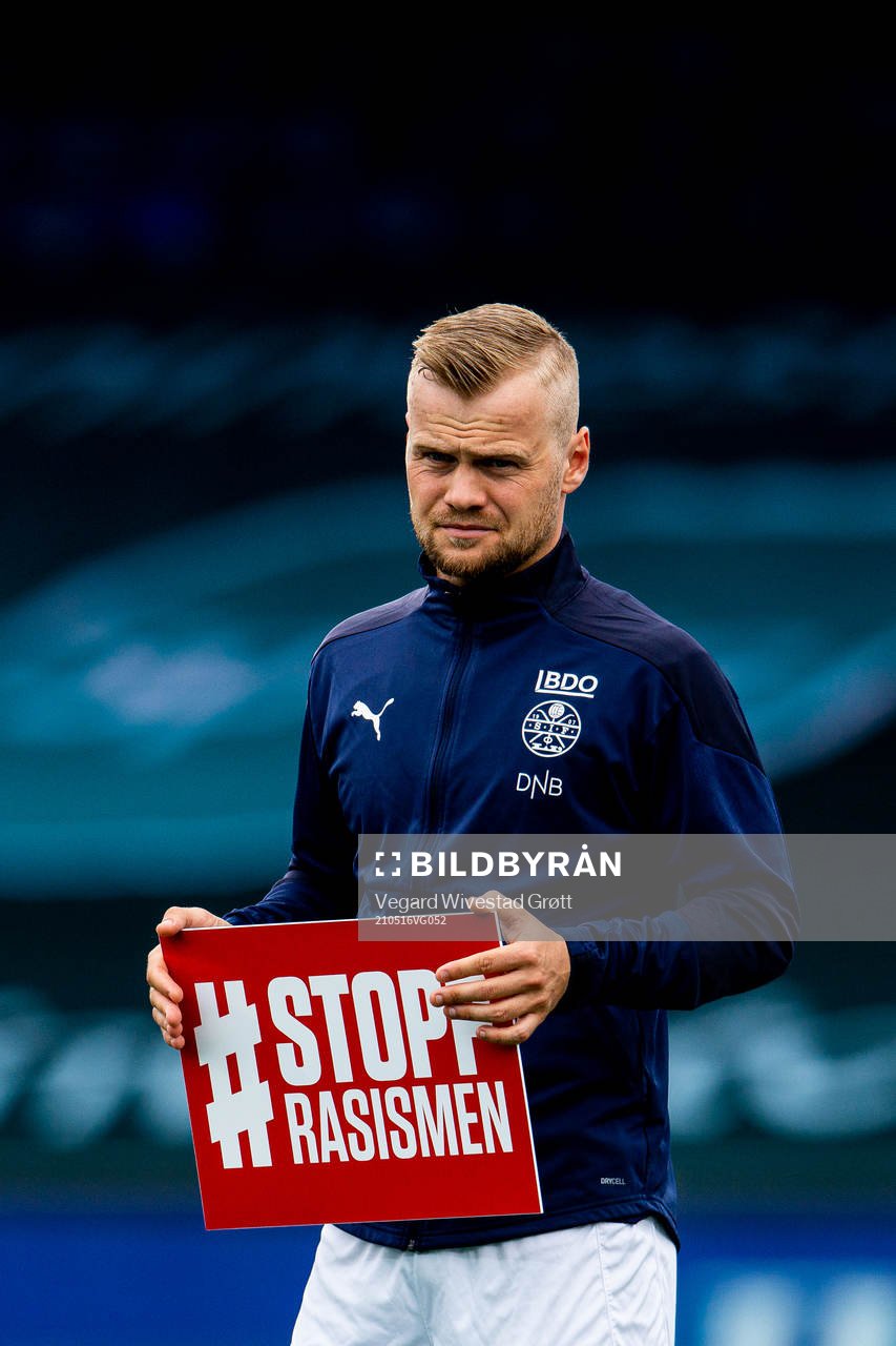 Herman Stengel of Strømsgodset holds a Stopp Rasismen sign
