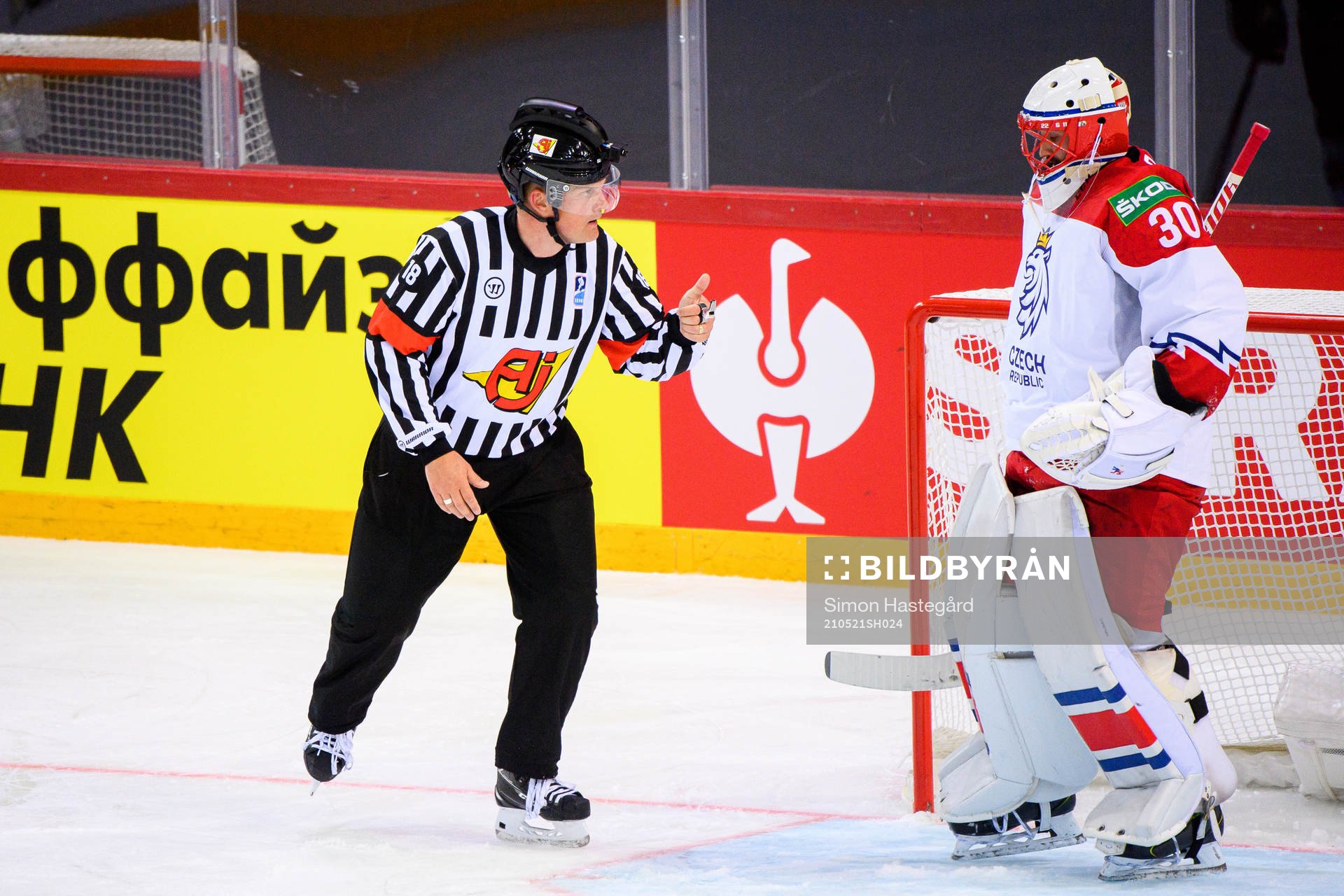 Referee Mikael Nord and goalkeeper Simon Hrubec of Czech