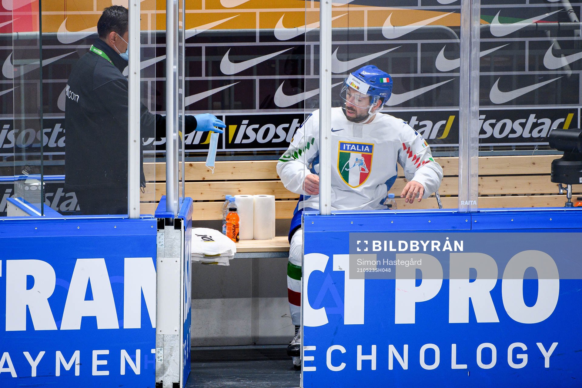 Stefano Giliati of Italy receives a face mask in the