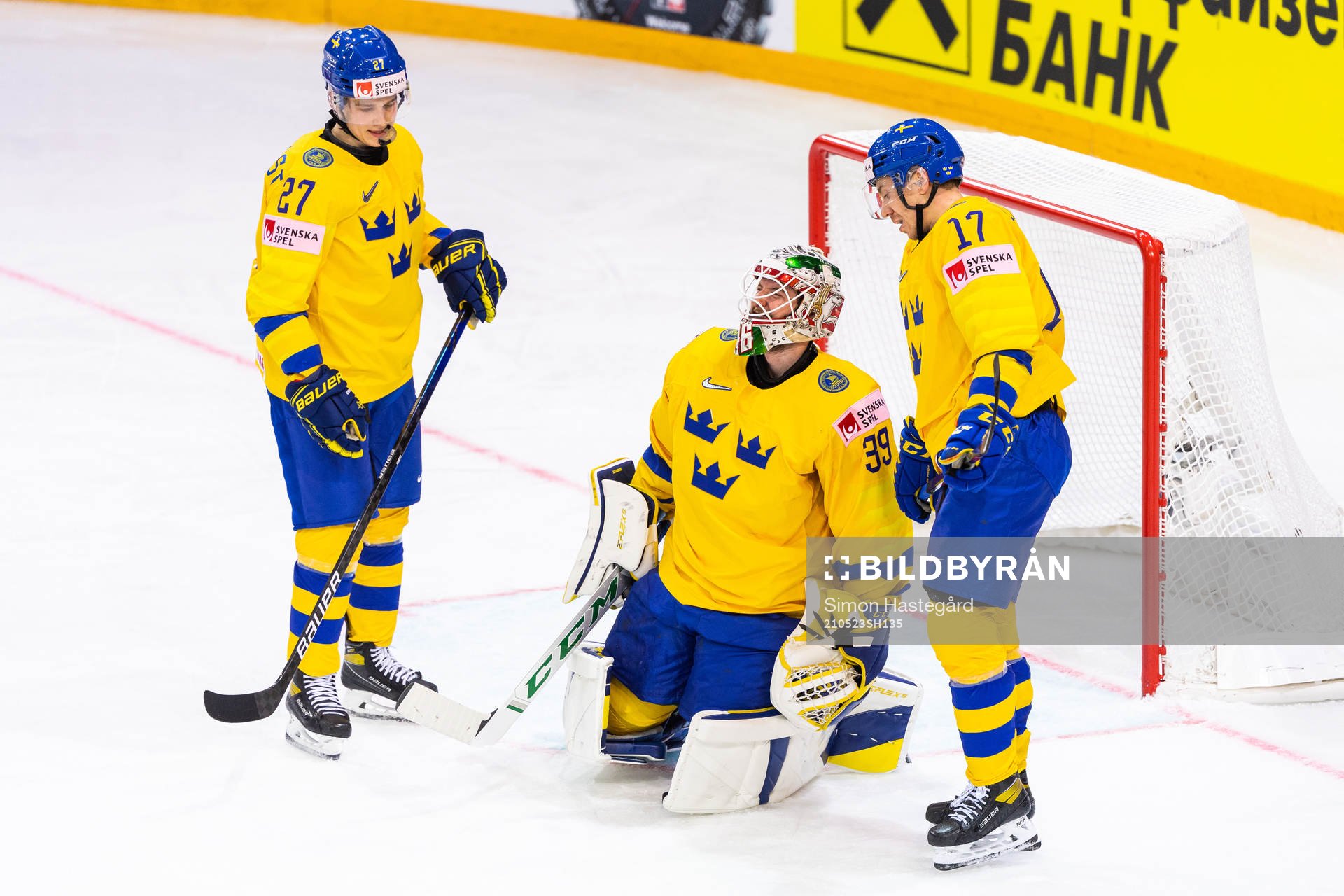Nils Lundkvist and Pär Lindholm attends to goalkeeper Adam