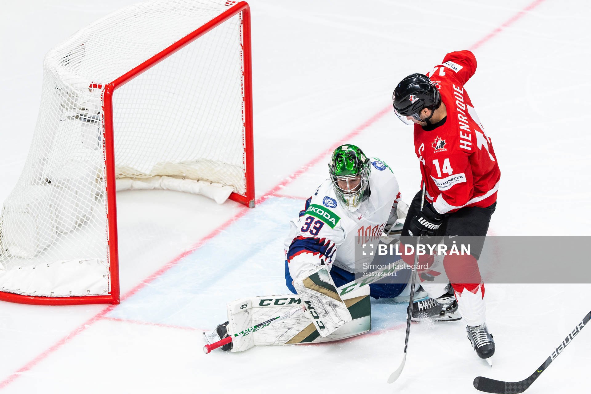 Goalkeeper Henrik Haukeland of Norway and Adam Henrique of