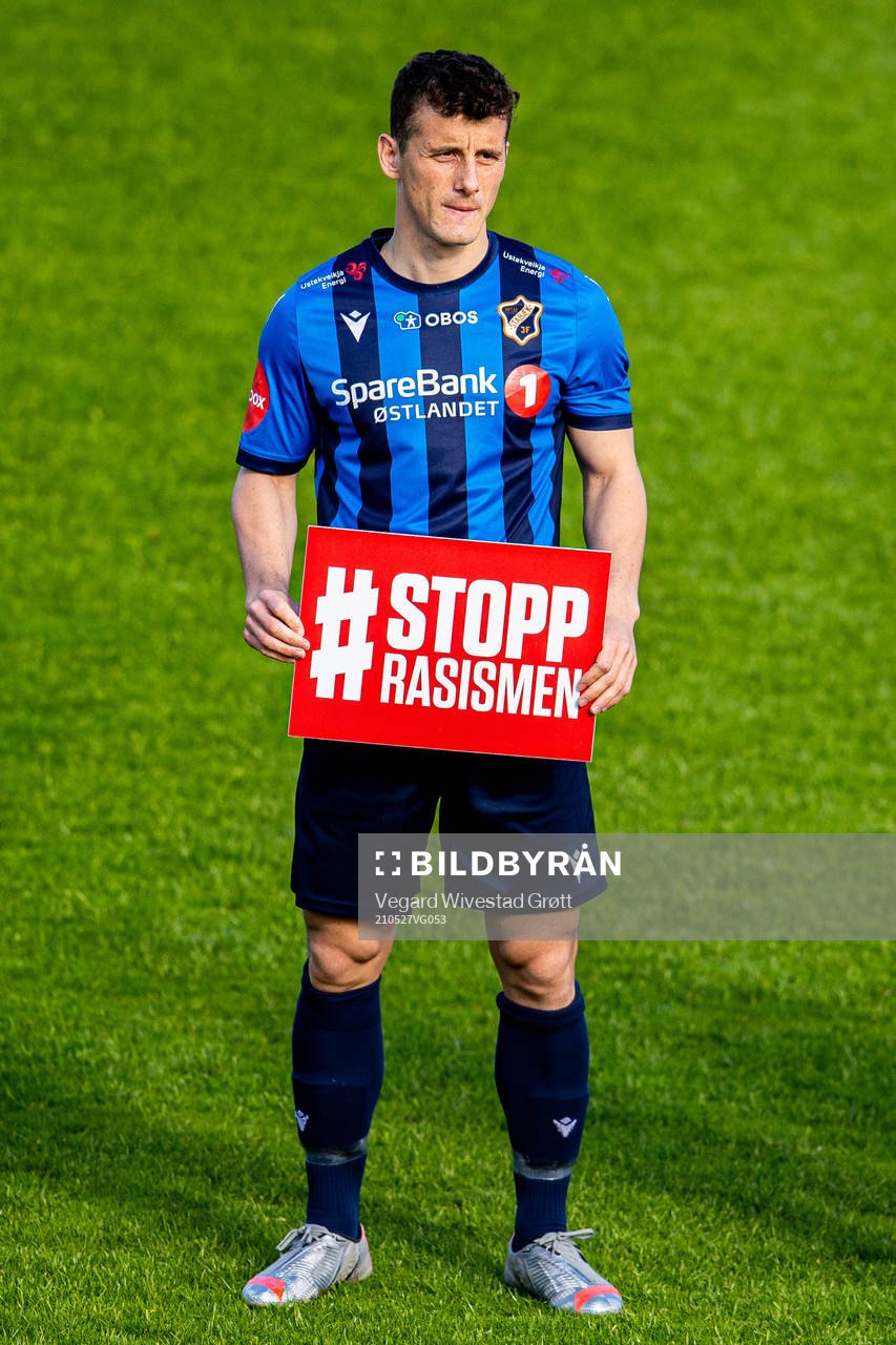 Herolind Shala of Stabæk holds a Stopp Rasismen sign ahead of the Eliteserien football match between Stabæk and Brann on May 27, 2021 in Bekkestua. 