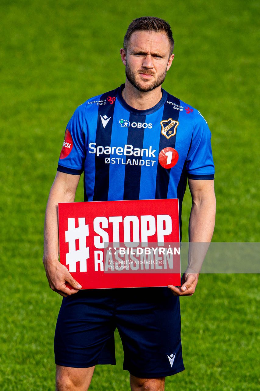 Mats Solheim of Stabæk holds a Stopp Rasismen sign