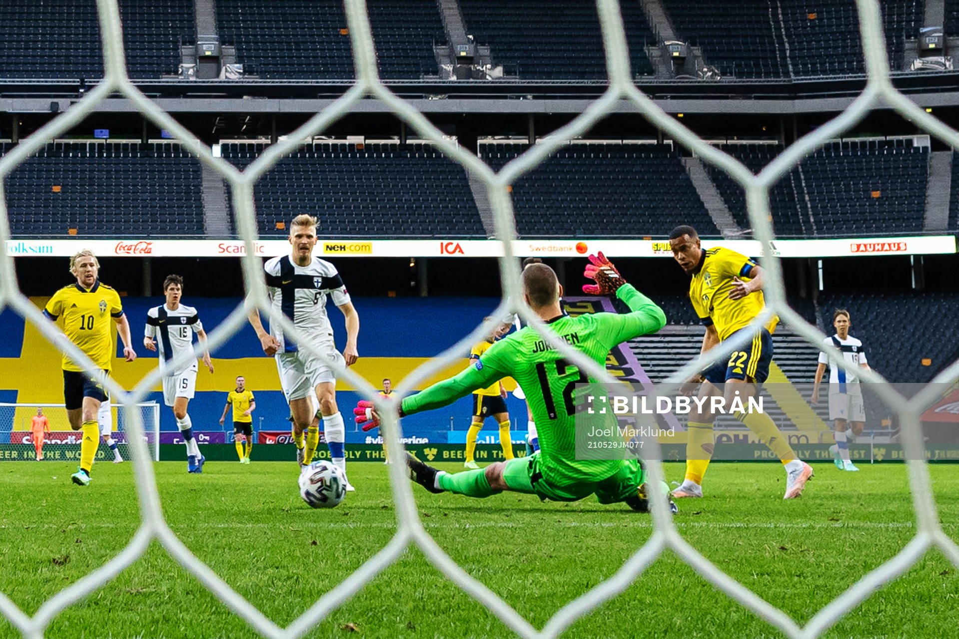 Robin Quaison of Sweden scores the 1-0 goal behind