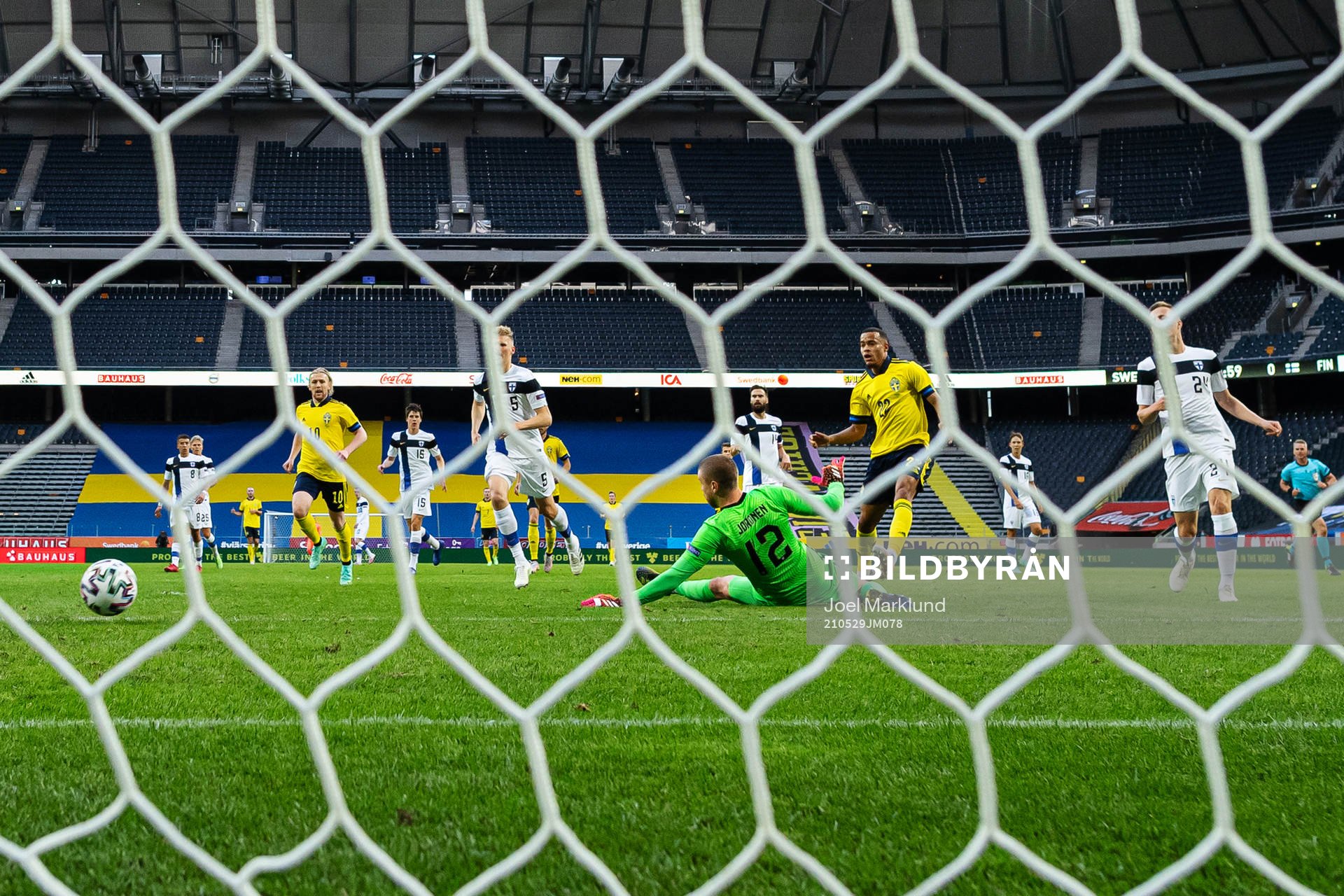 Robin Quaison of Sweden scores the 1-0 goal behind