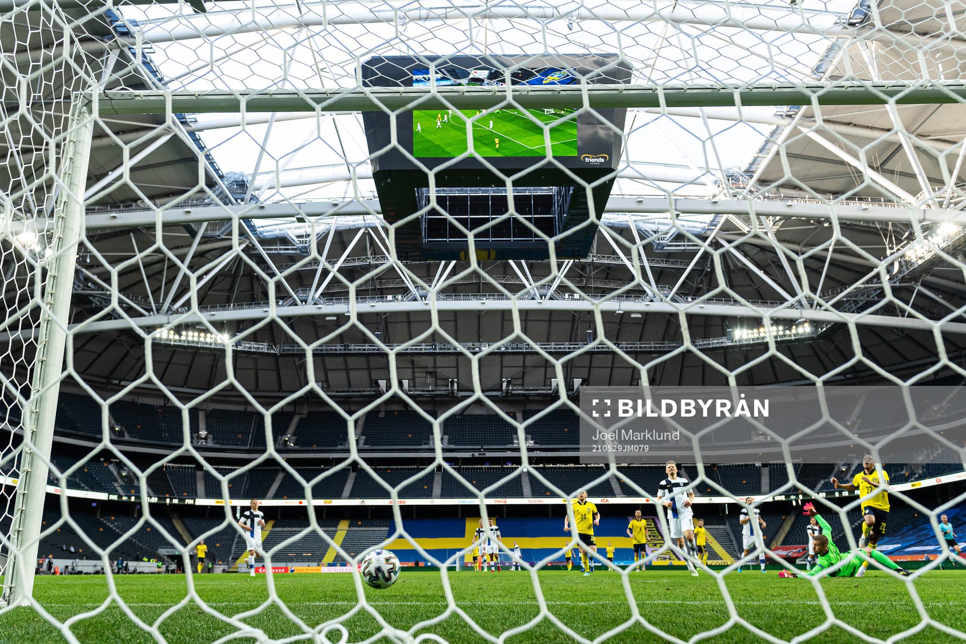 Robin Quaison of Sweden scores the 1-0 goal behind
