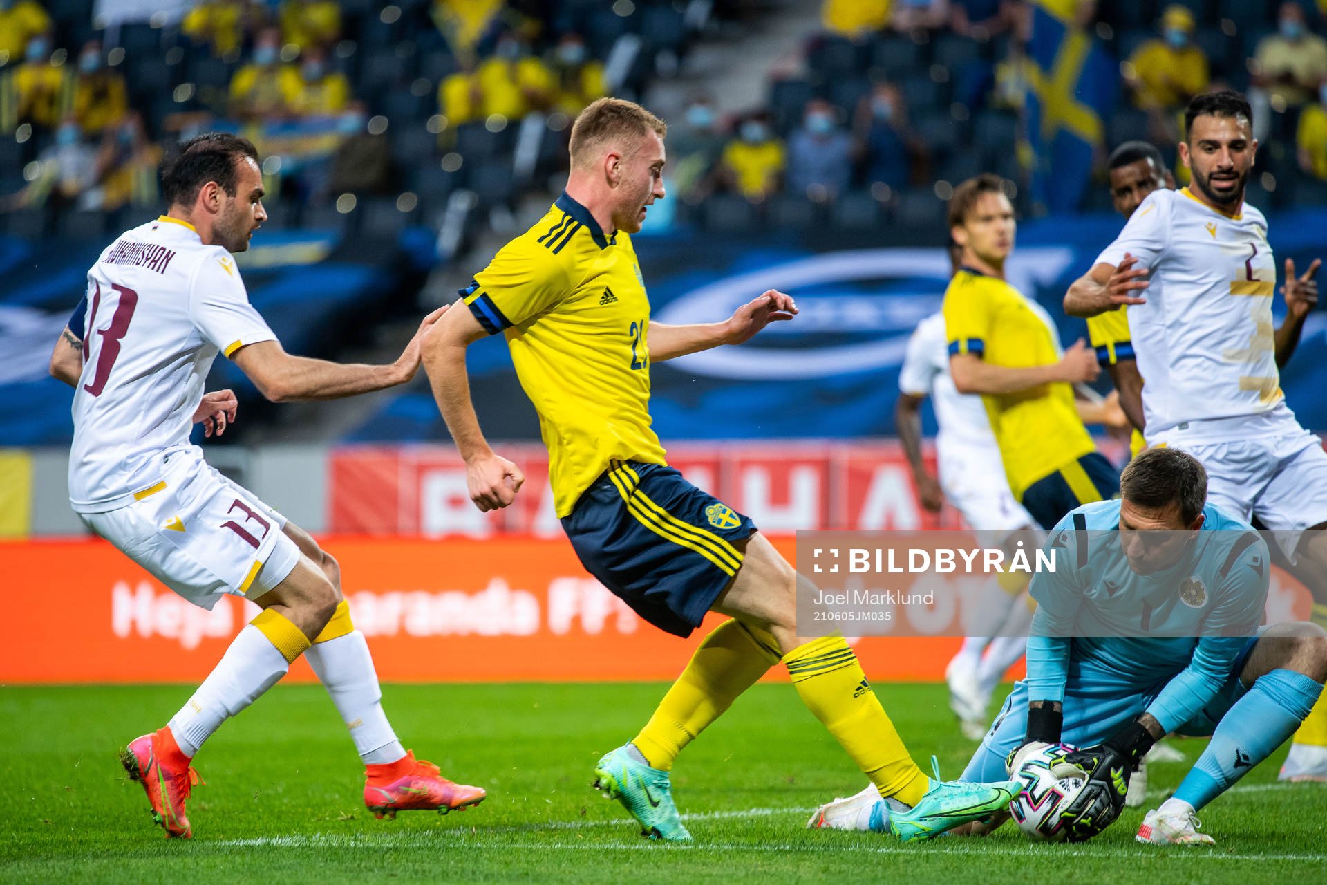 Kamo Hovhannisyan and goalkeeper Davit Yurchenko of Armenia