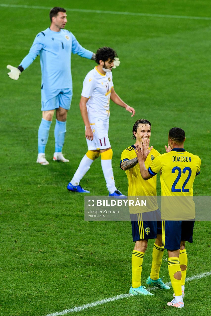 Sebastian Larsson and Robin Quaison of Sweden celebrate