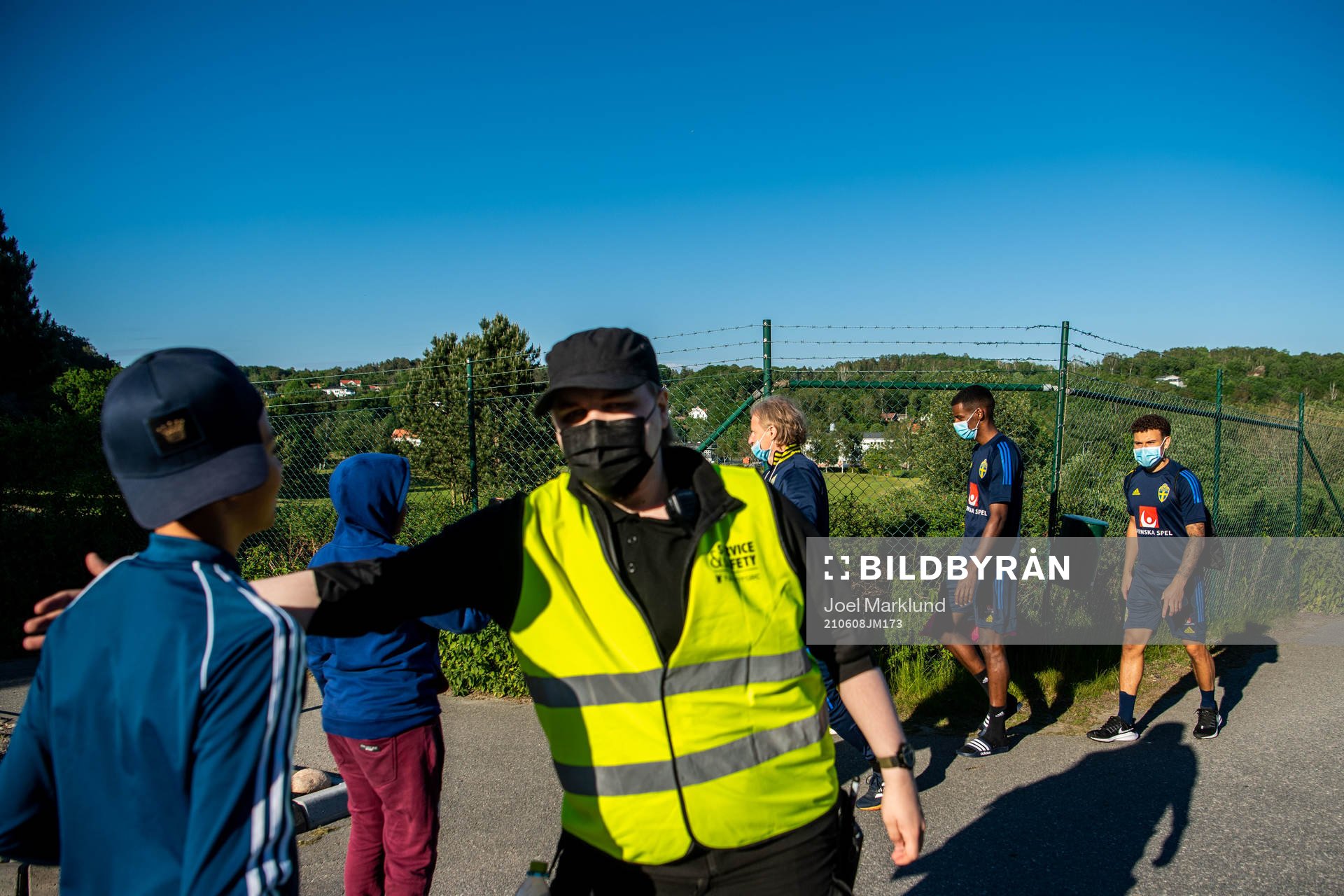 A security guard stops kids from talking to team manager