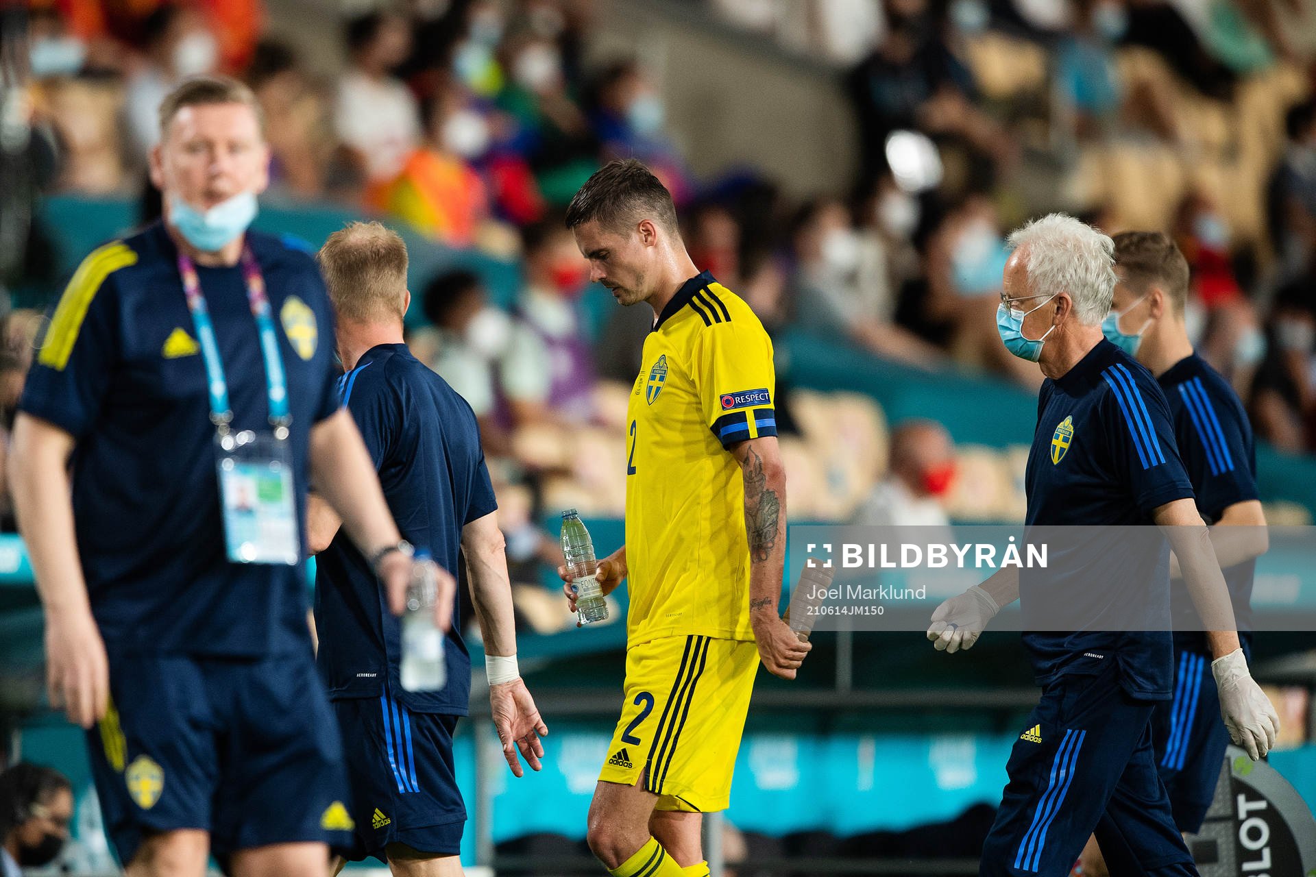 Mikael Lustig of Sweden leaves the pitch injured