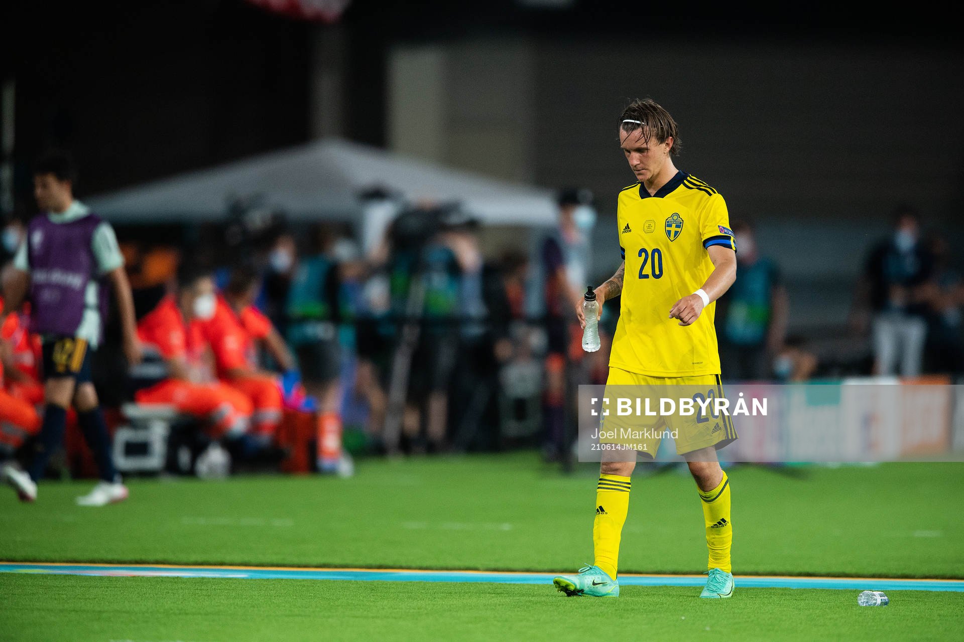 Kristoffer Olsson of Sweden leaves the pitch in pain