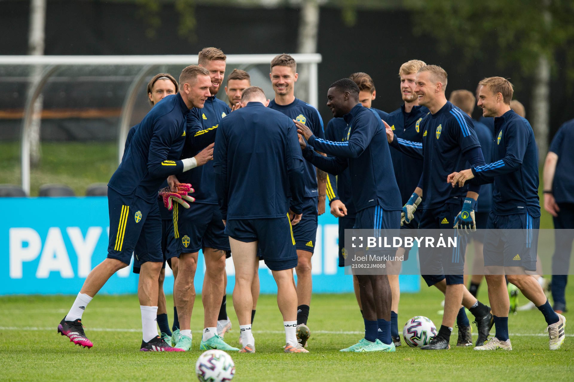 Players of Sweden joking with Emil Krafth of the Swedish