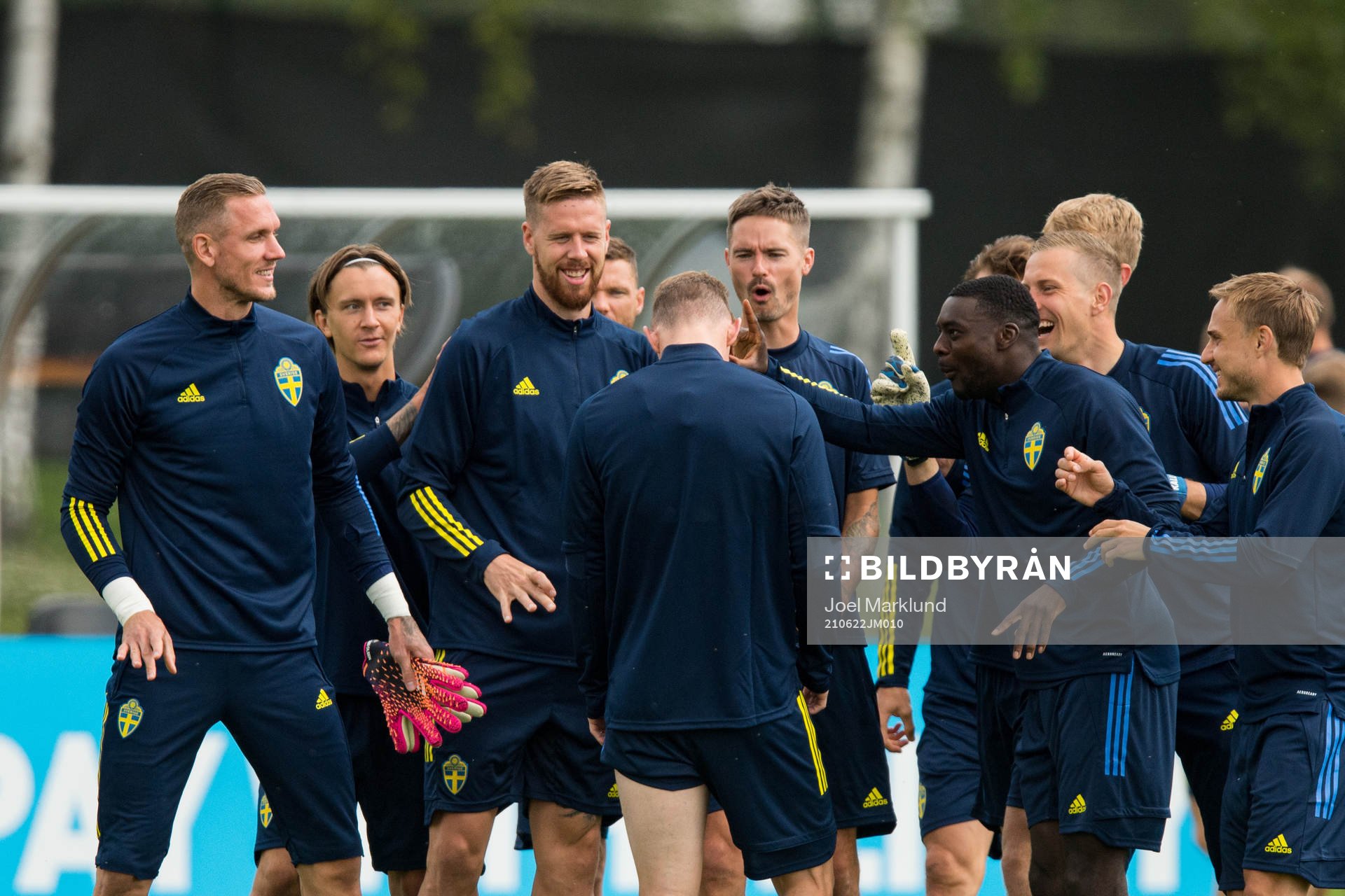 Players of Sweden joking with Emil Krafth of the Swedish