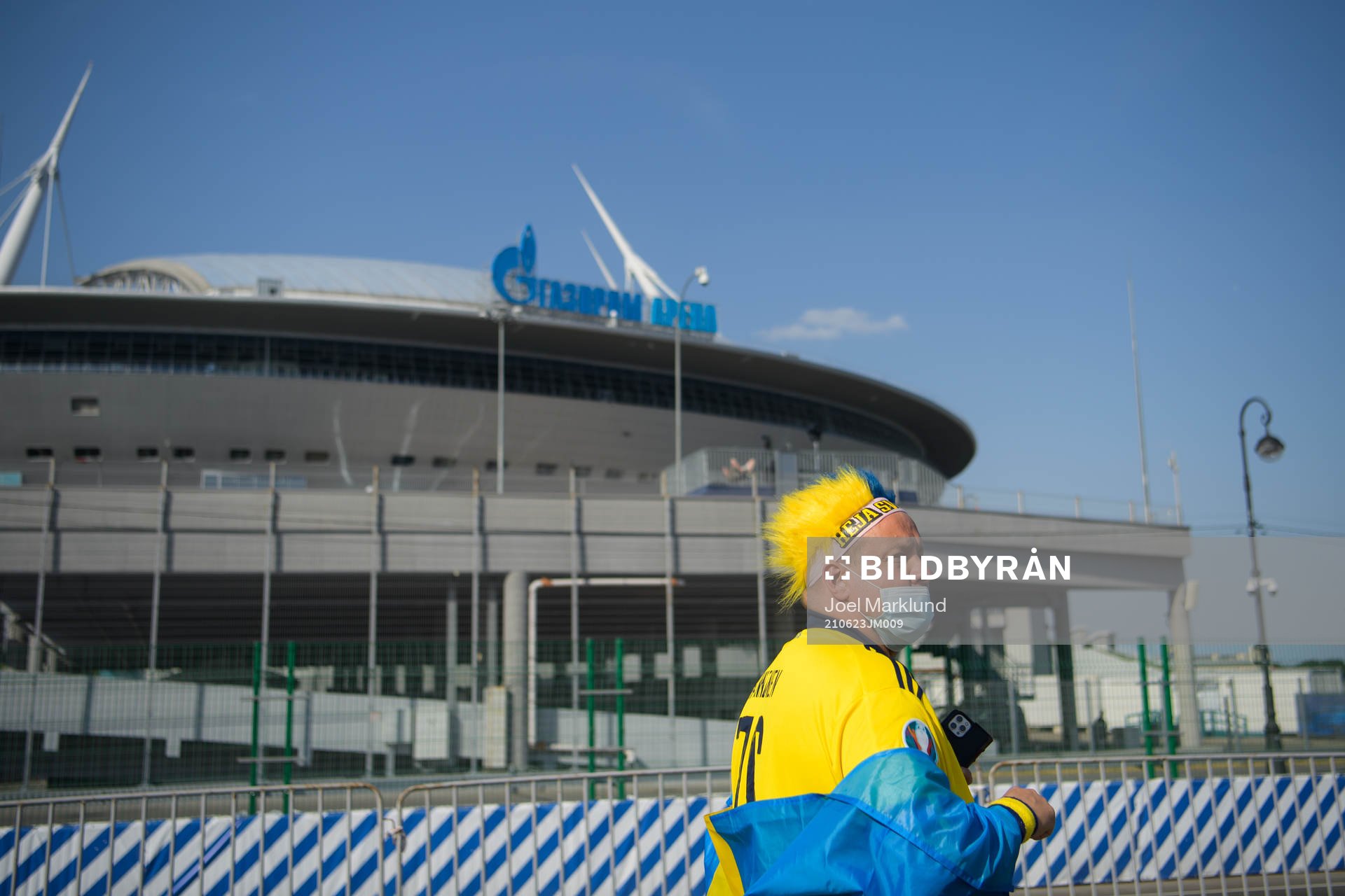 A Swedish fan walks past Saint Petersburg Stadium