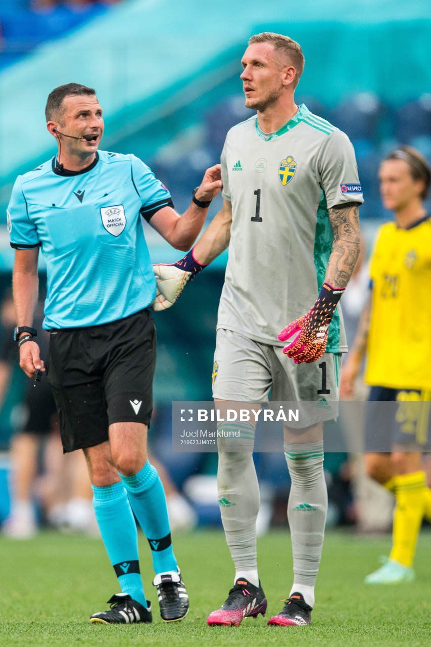 Referee Michael Oliver and goalkeeper Robin Olsen of Sweden