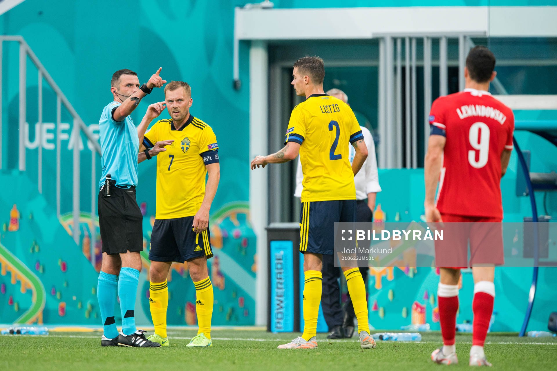 Referee Michael Oliver with Sebastian Larsson and Mikael