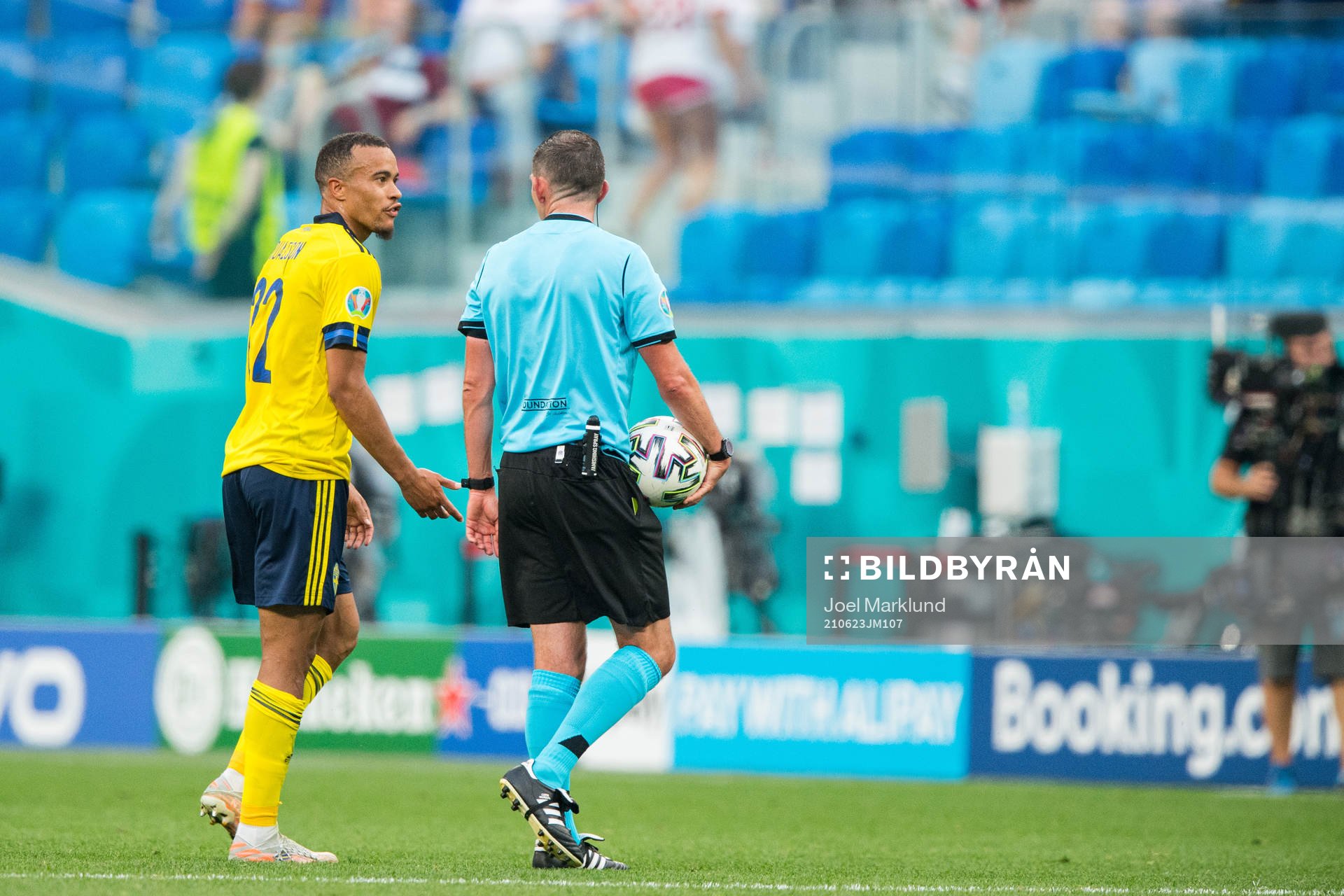 Robin Quaison of Sweden and referee Michael Oliver