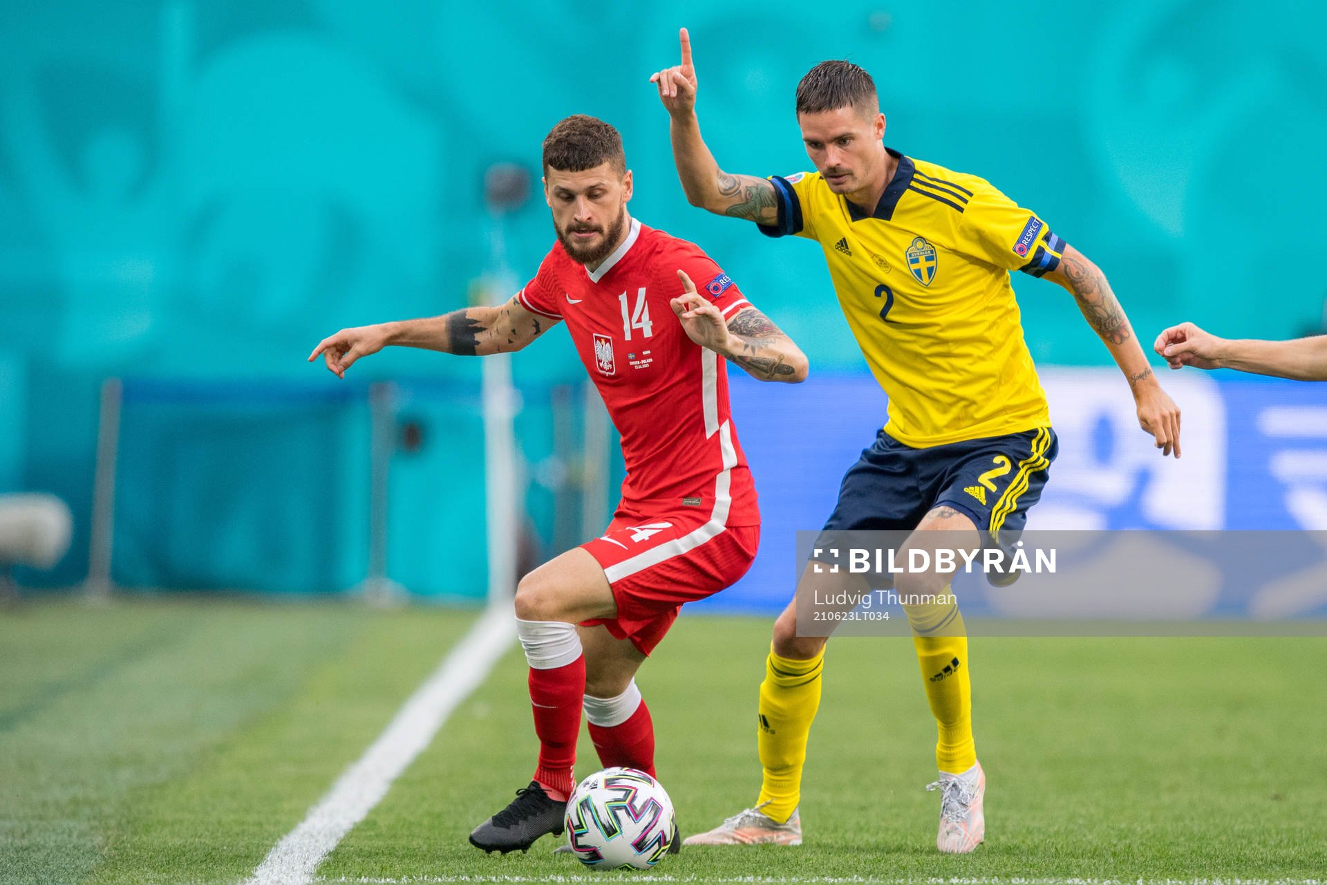 Mateusz Klich of Poland and Mikael Lustig of Sweden