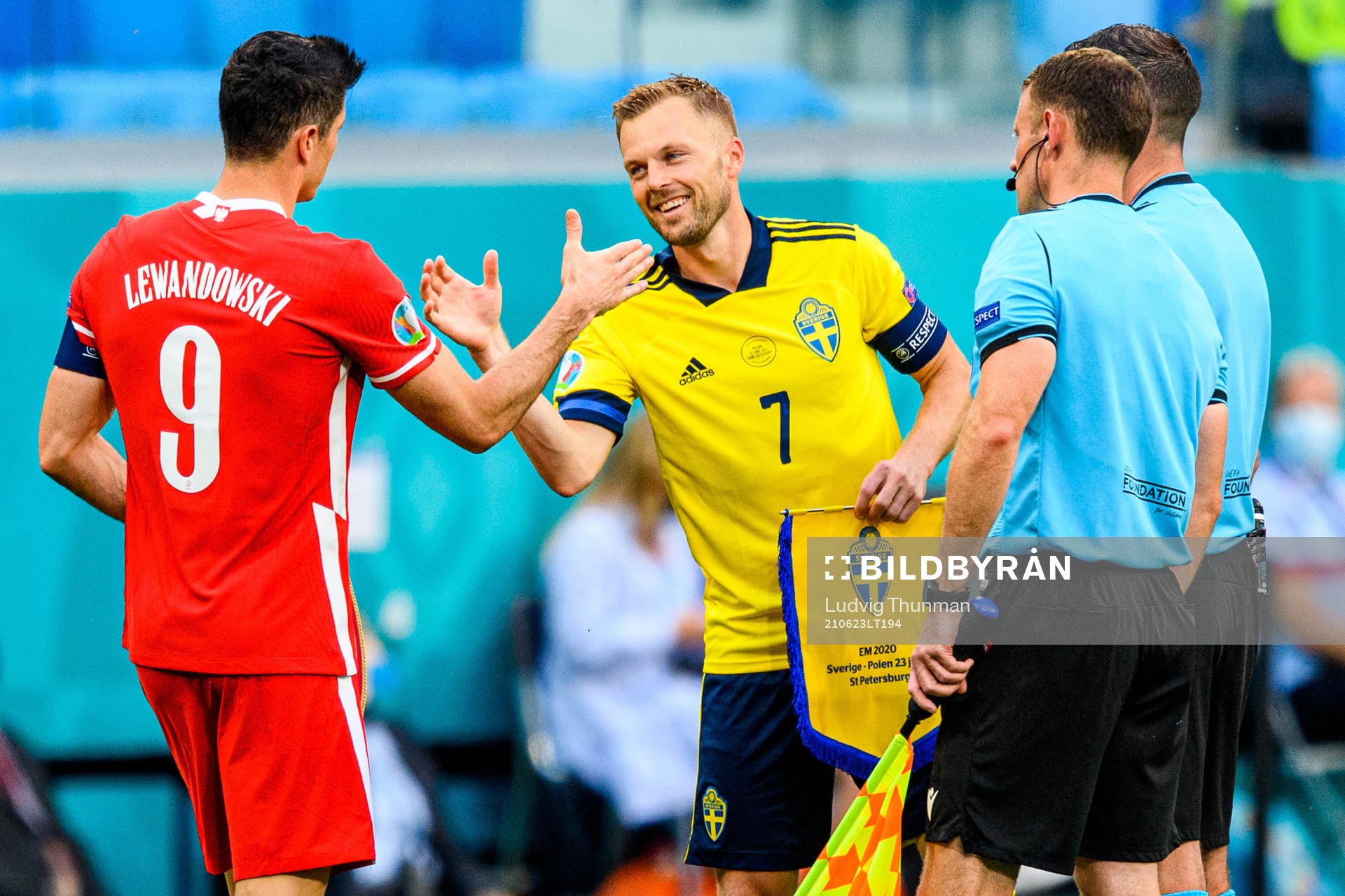 Robert Lewandowski of Poland and Sebastian Larsson of Sweden