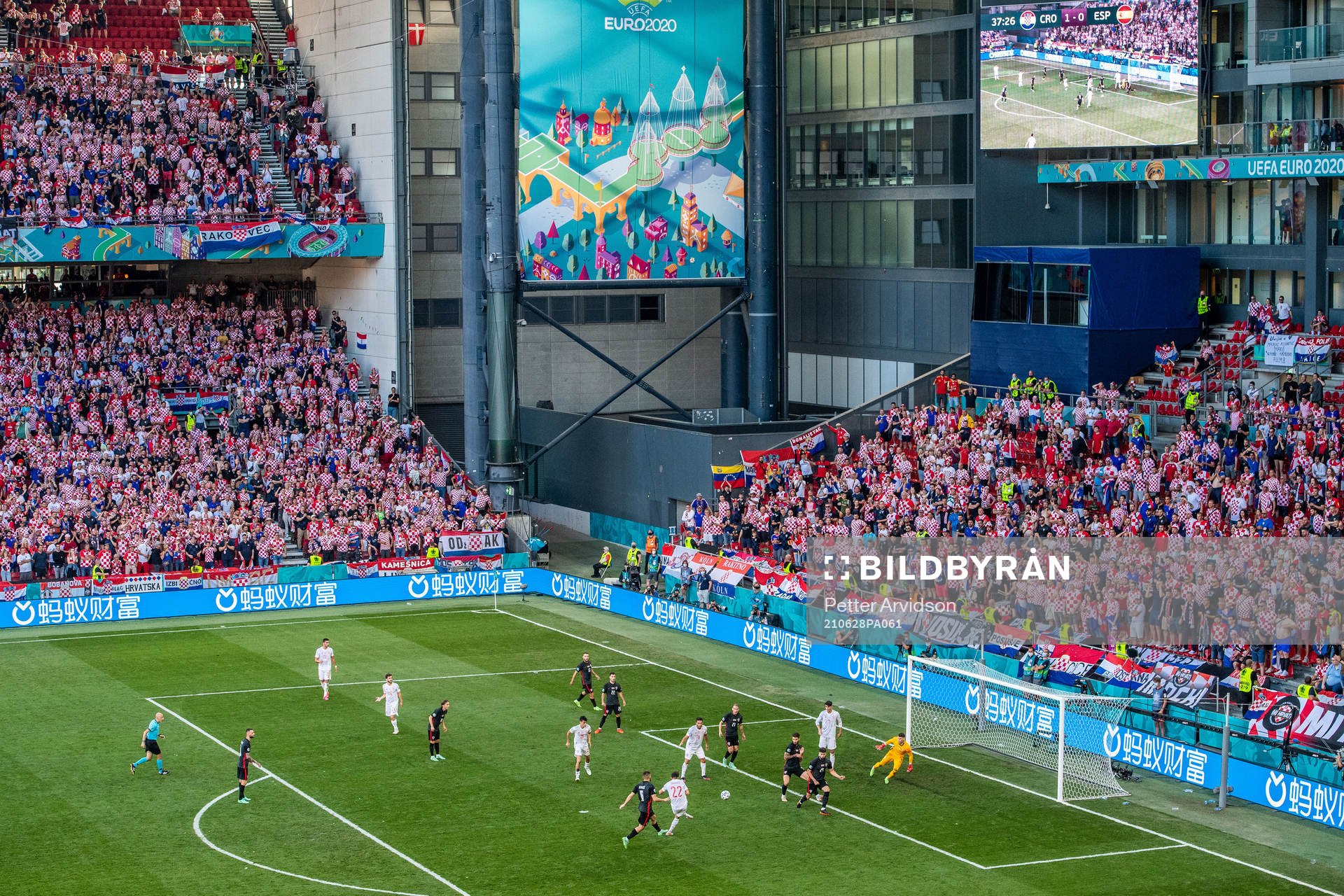 Pablo Sarabia of Spain scores 1-1 behind goalkeeper Dominik