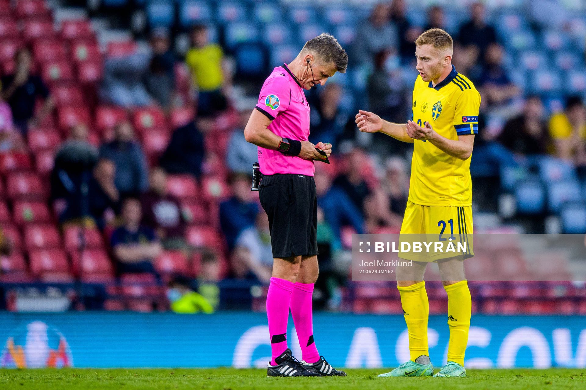 referee Daniele Orsato and Dejan Kulusevski of Sweden